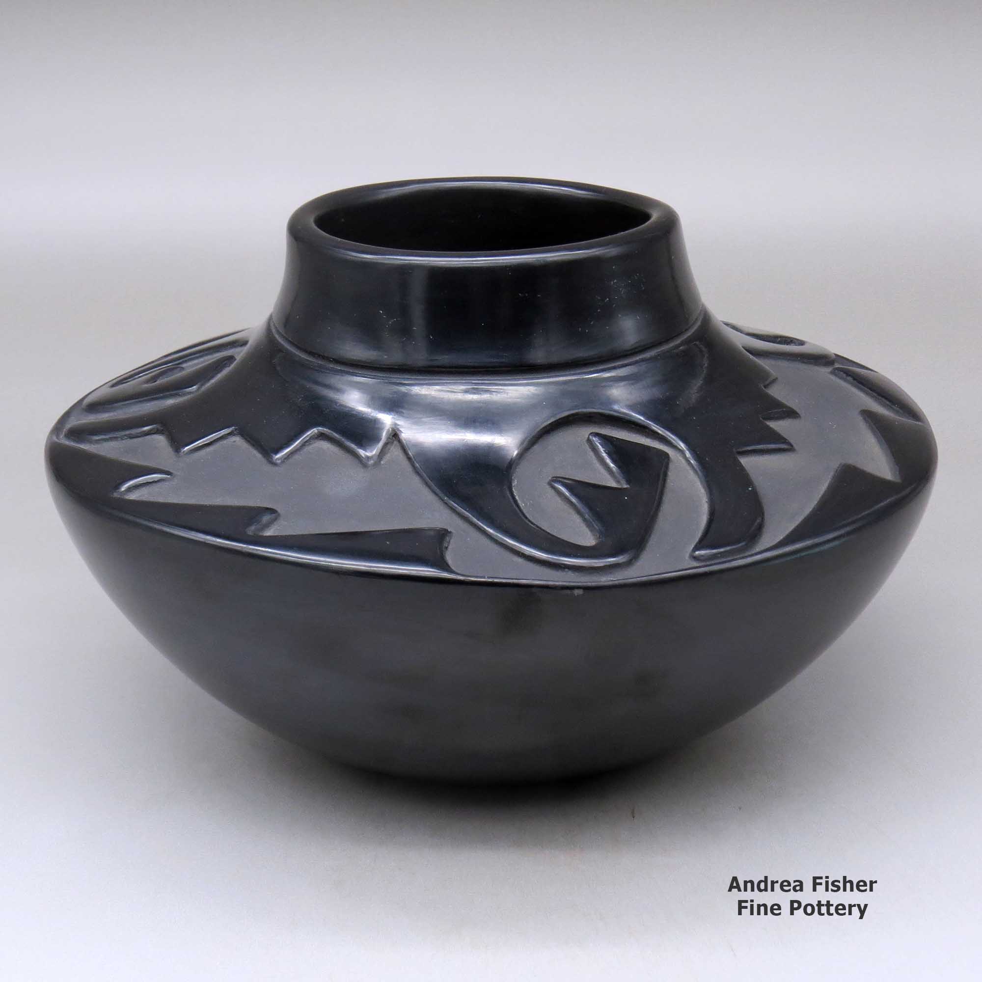 Click or tap to see a larger view A high-shoulder black jar with a three-panel geometric design carved above the shoulder made by Elizabeth Naranjo of Santa Clara