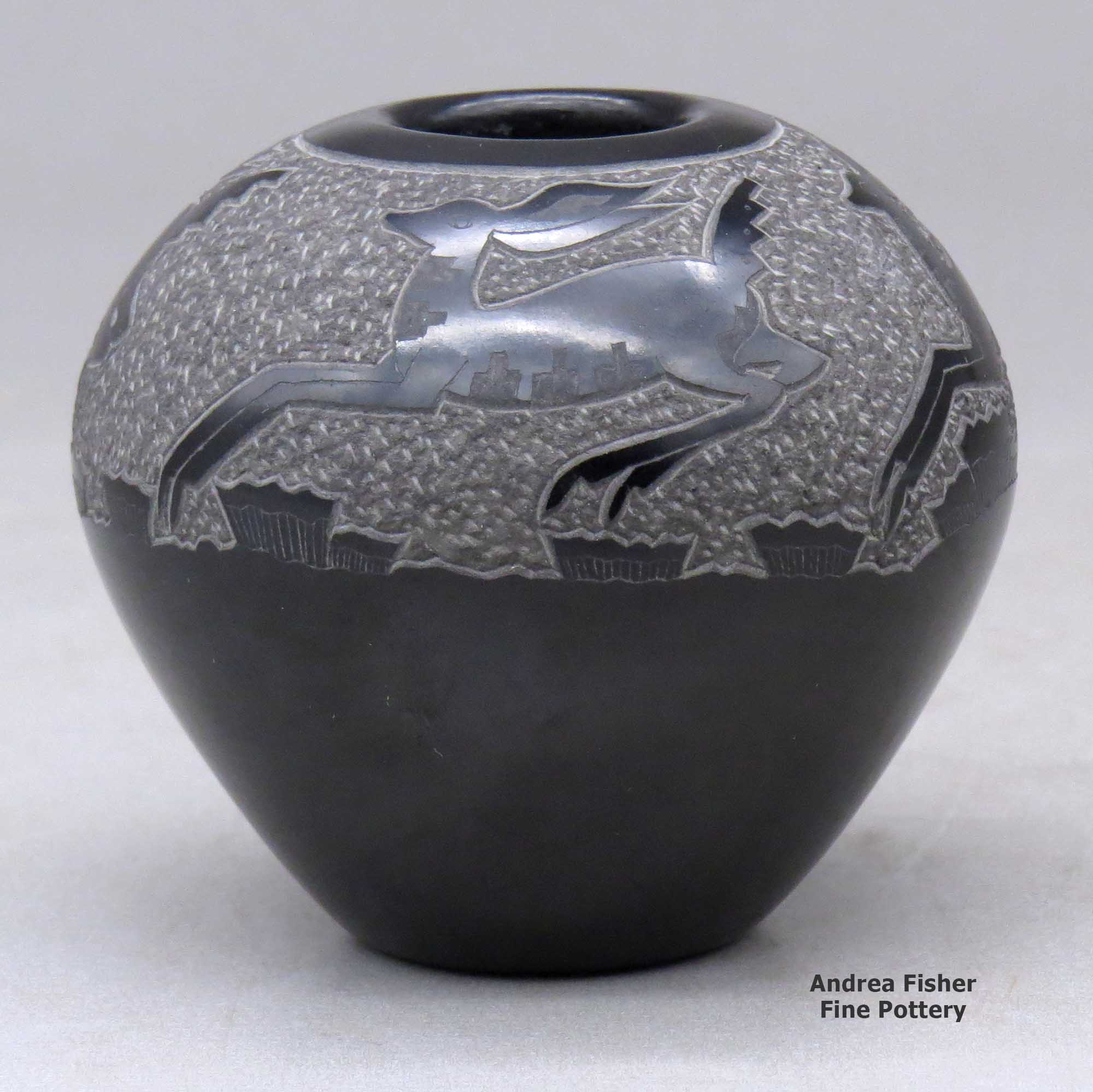Click or tap to see a larger view A black seed pot decorated with a sgraffito deer and geometric design above the shoulder made by Goldenrod of Santa Clara