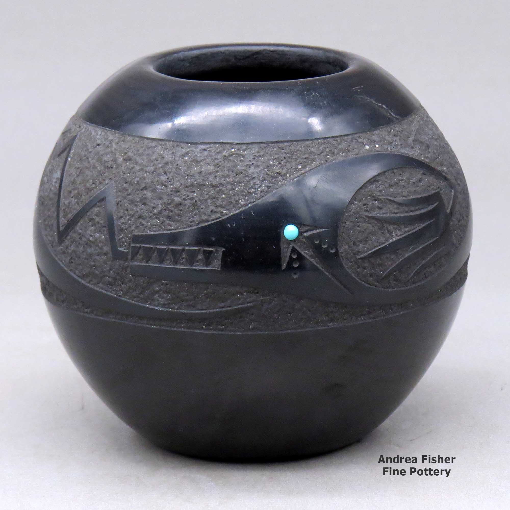 Click or tap to see a larger view A black bowl decorated with an inlaid stone and a sgraffito plumed avanyu, cloud formation and geometric design made by John Gonzales of San Ildefonso