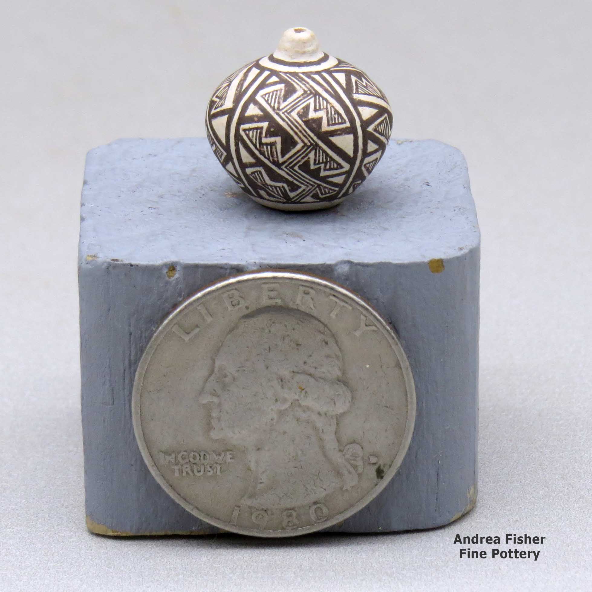 Click or tap to see a larger view Miniature black-on-white seed pot with a four-panel fine line and geometric design made by Thomas Natseway of Laguna