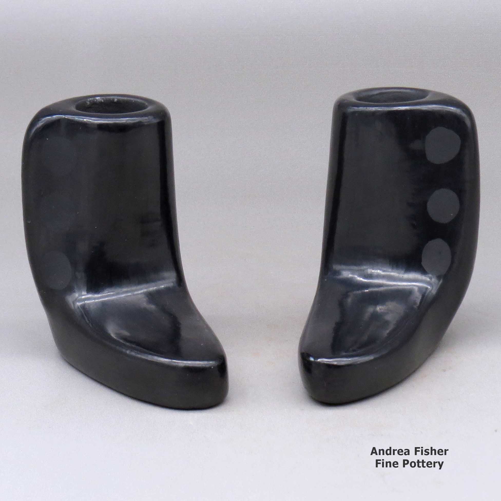 Click or tap to see a larger view A pair of black candlestick holders made by Blue Corn of San Ildefonso