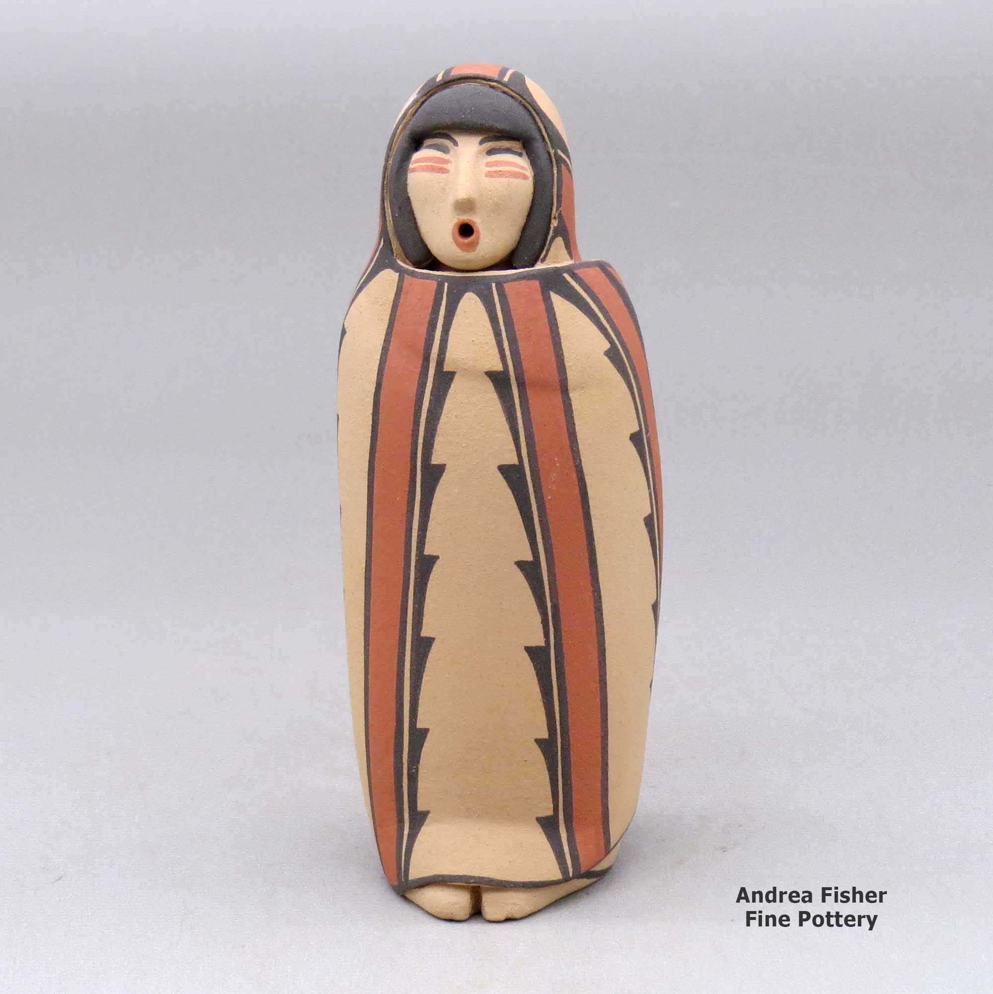 Click or tap to see a larger view A polychrome Singing Mother wearing a manta decorated with a geometric design made by Maxine Toya of Jemez