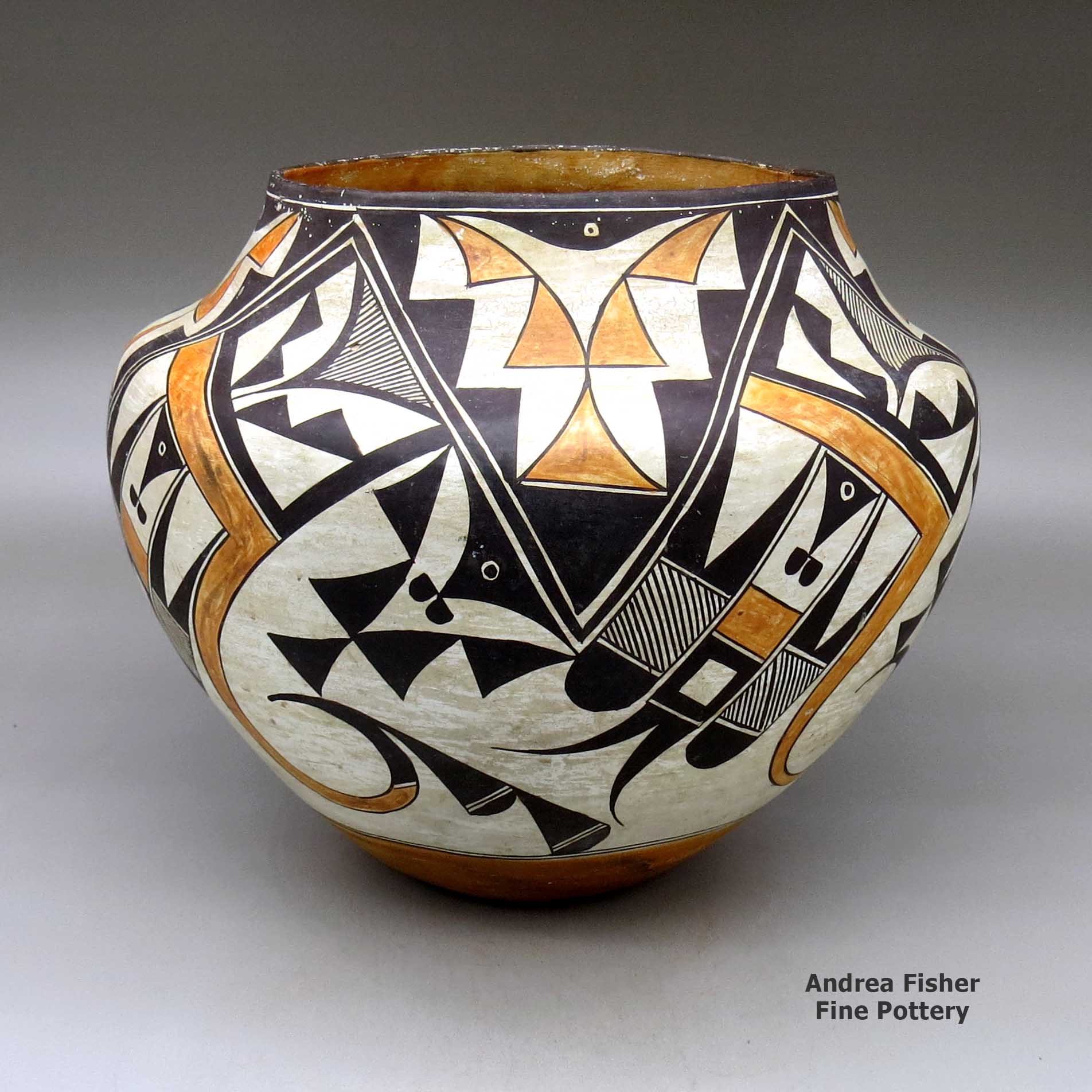 Click or tap to see a larger view A polychrome jar decorated with a four panel bird element and geometric design made by Unknown of Acoma