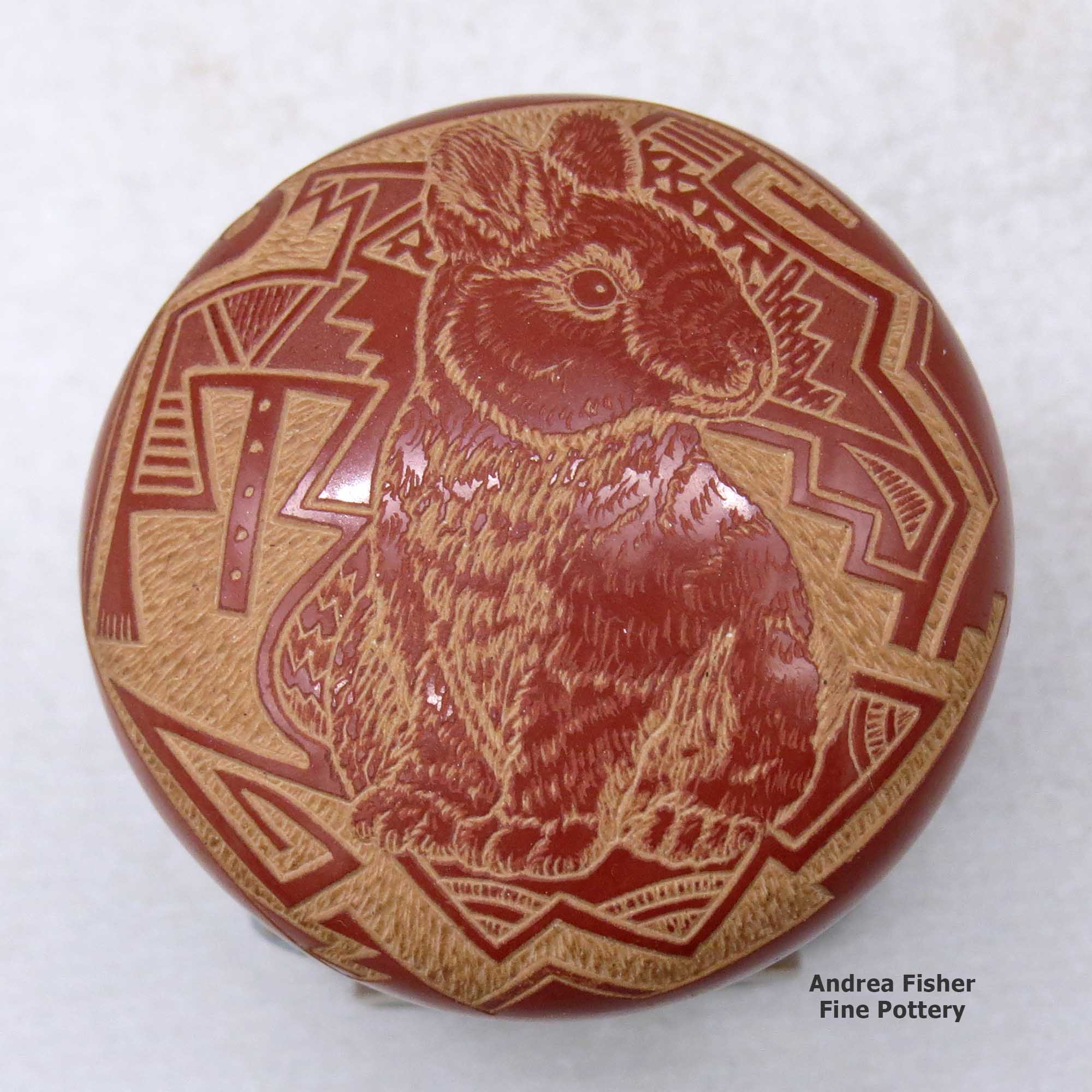 Click or tap to see a larger view A miniature red seed pot decorated with a sgraffito rabbit and geometric design made by Rosemary Lonewolf of Santa Clara