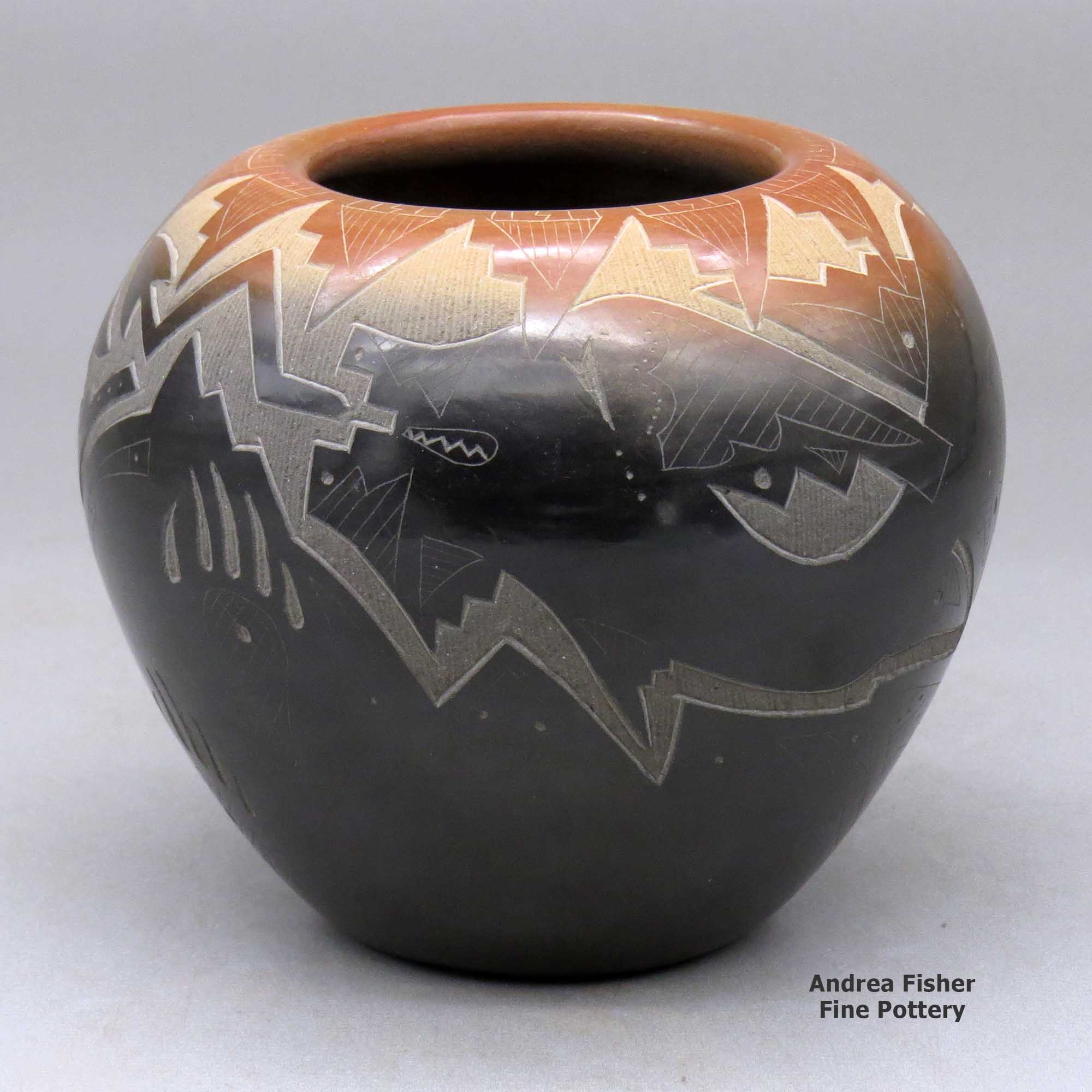 Click or tap to see a larger view A black bowl with a sienna rim and decorated with a sgraffito avanyu and geometric design made by Sammy Naranjo of Santa Clara