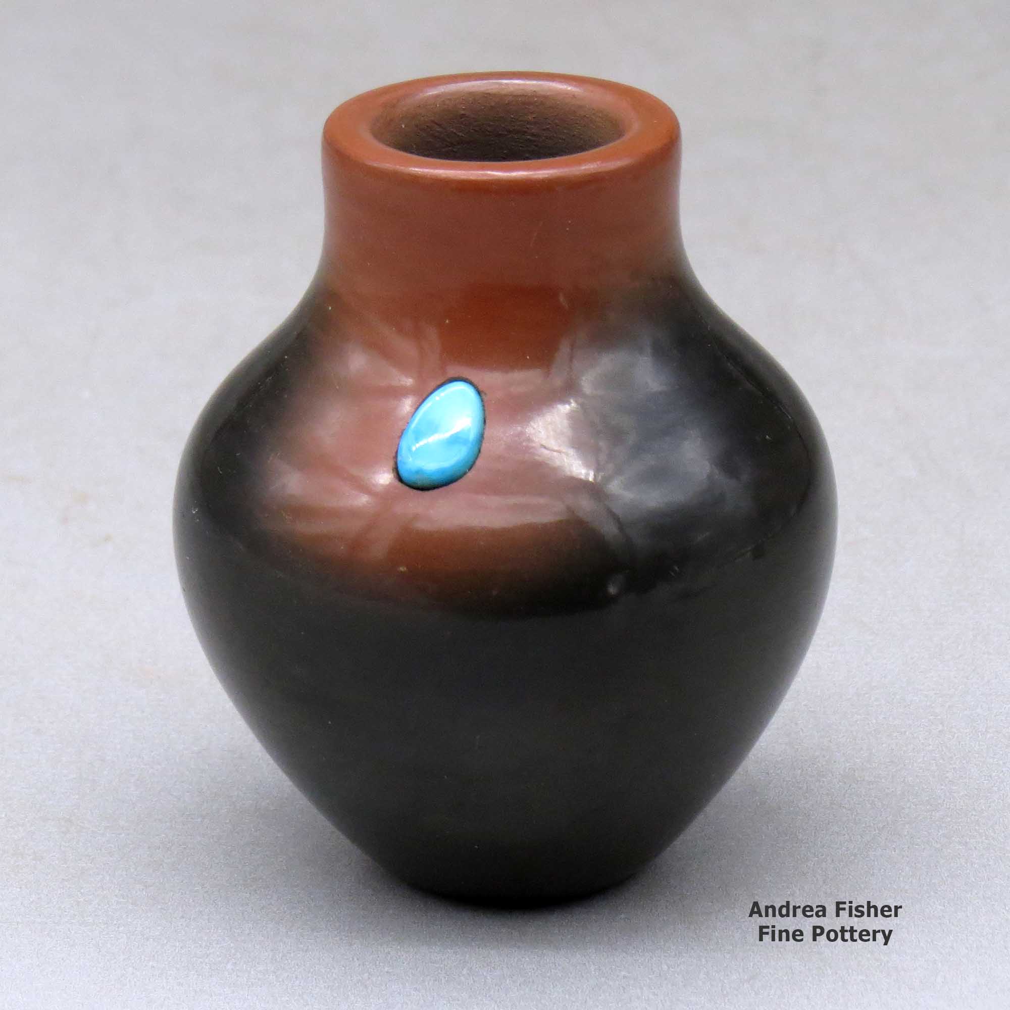 Click or tap to see a larger view A miniature two-tone jar with an inlaid stone made by Dora Tse Pe of San Ildefonso