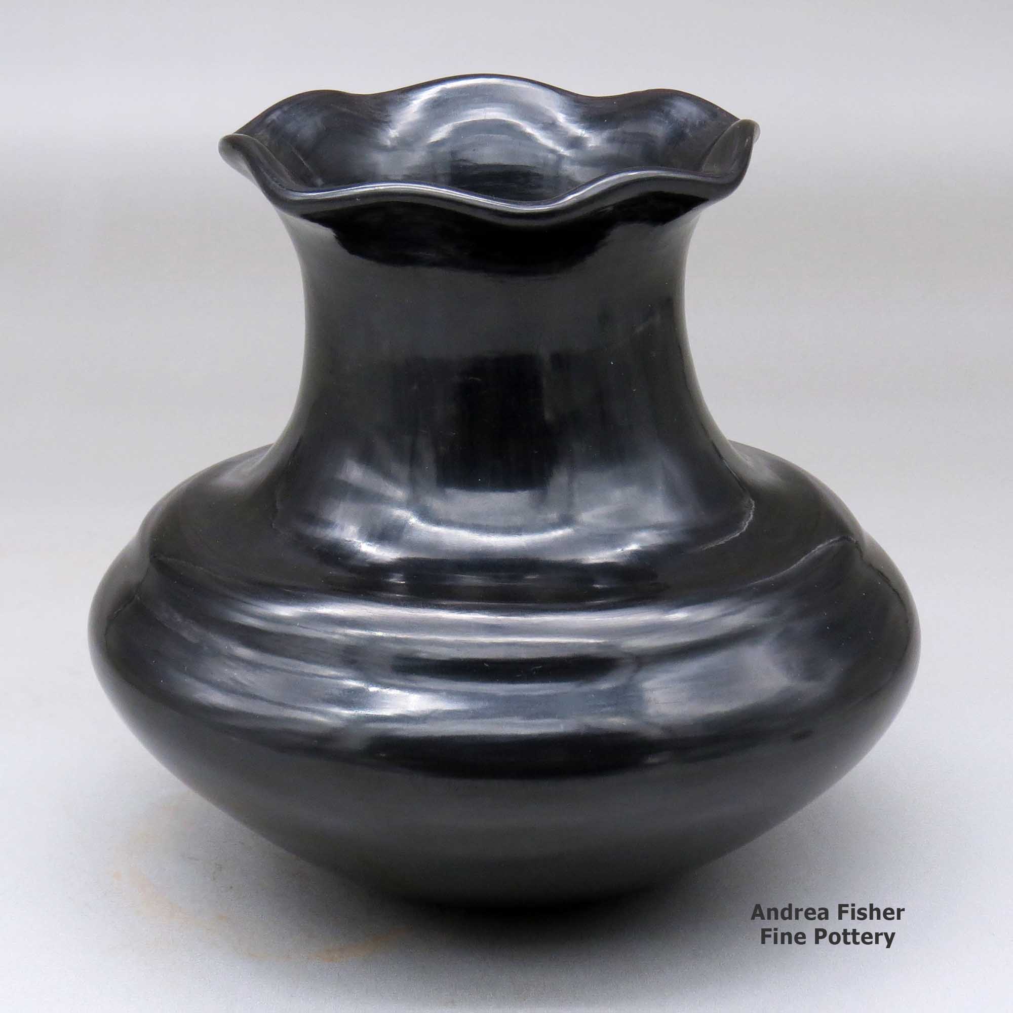 Click or tap to see a larger view A double-shouldered black jar with a tall neck and pie crust rim made by Tina Garcia of Santa Clara