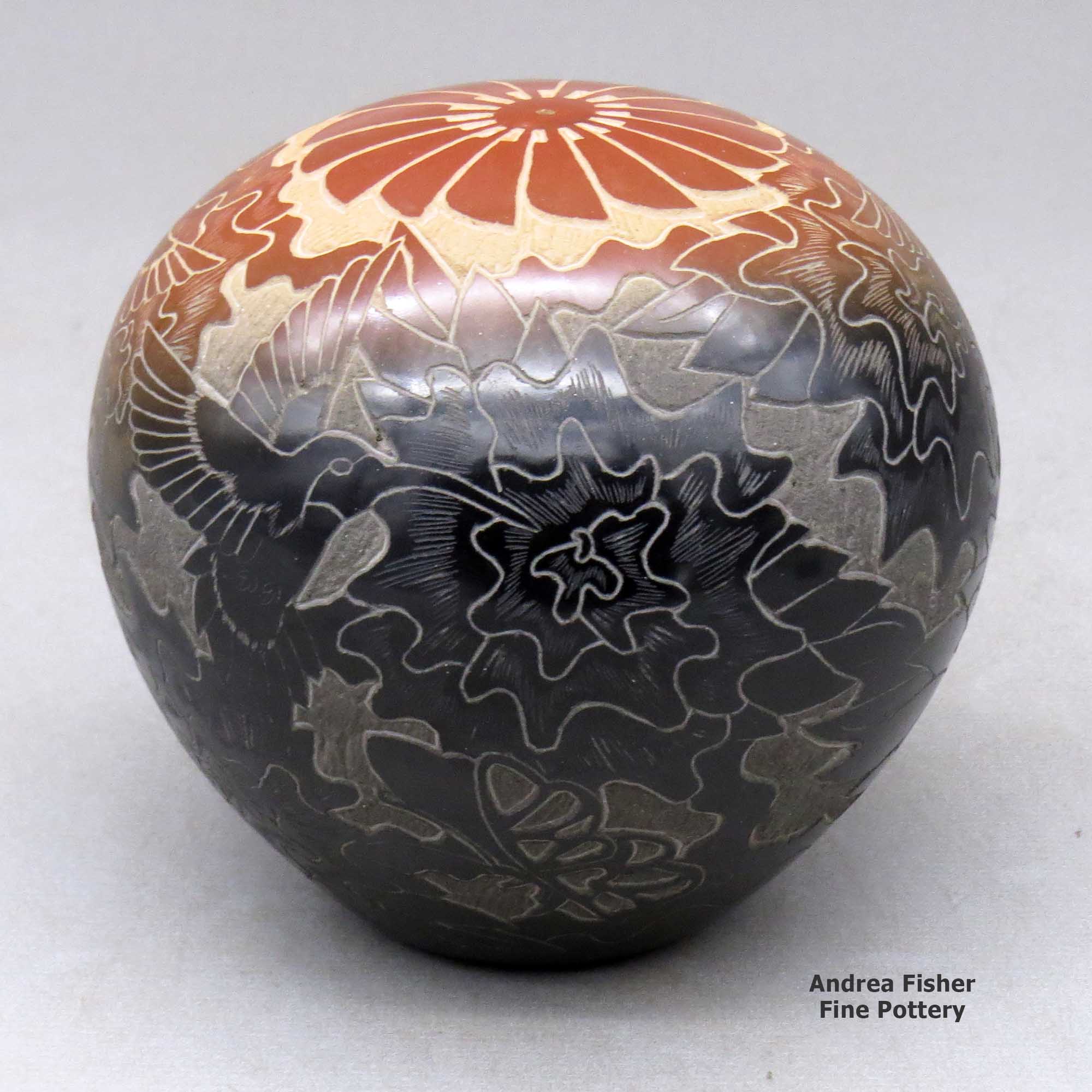 Click or tap to see a larger view A two-tone seed pot decorated with a sgraffito hummingbird, flower, plants, feathers and geometric design made by Eric Tafoya of Santa Clara
