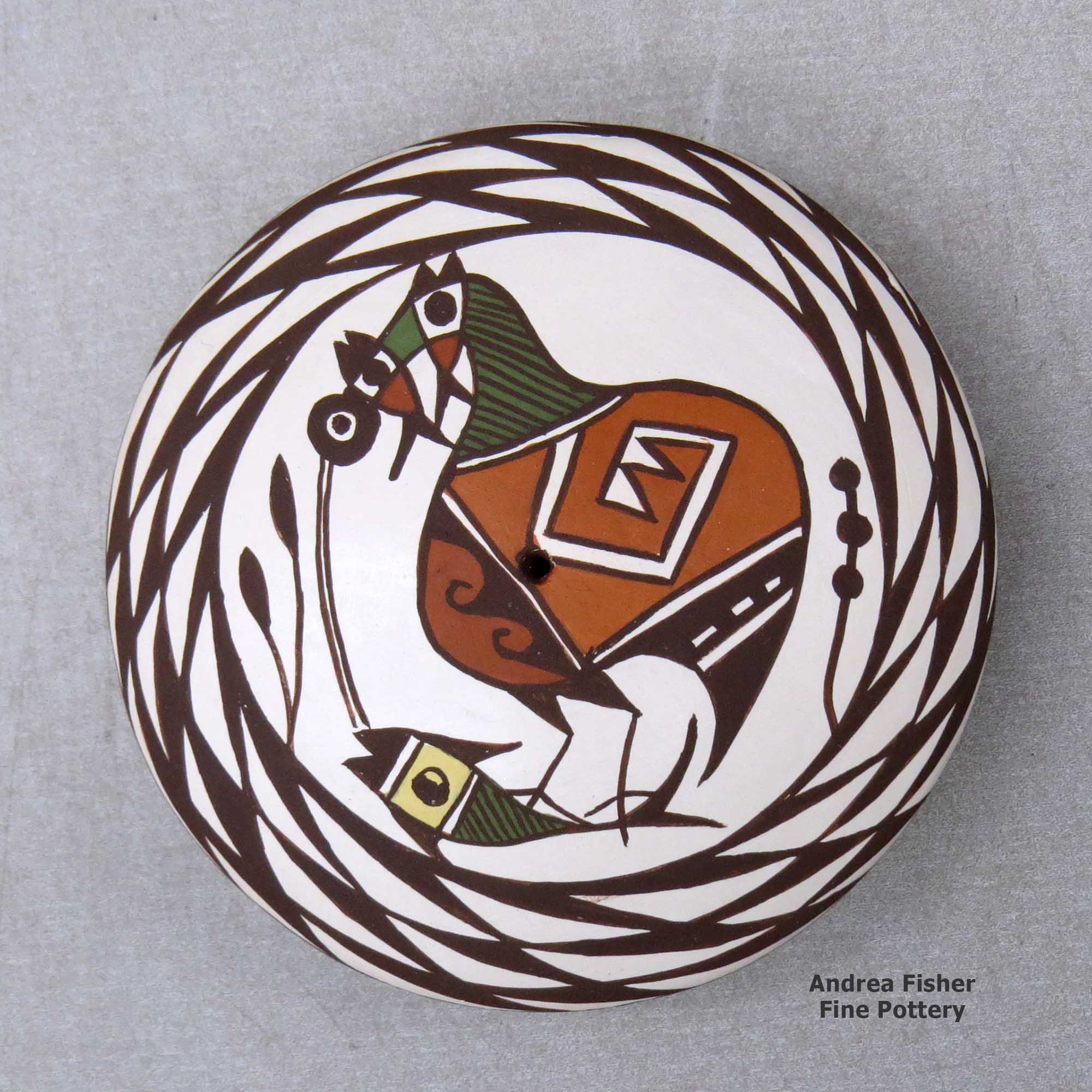 Click or tap to see a larger view A polychrome seed pot decorated above the shoulder with a cloudeater, fish and spiral mesa geometric design made by Diane Lewis of Acoma