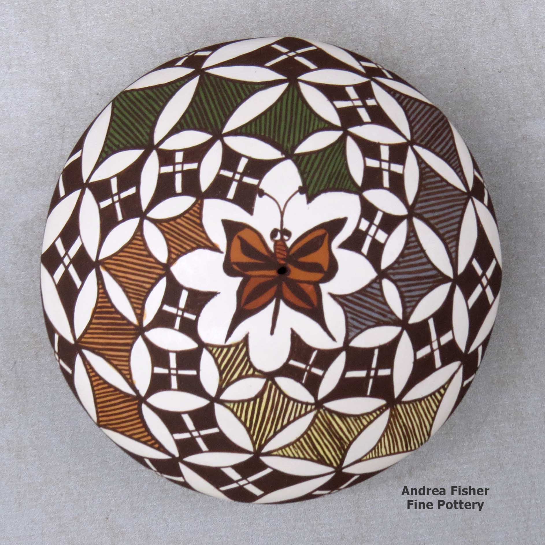 Click or tap to see a larger view A polychrome seed pot decorated above the shoulder with a butterfly and geometric design made by Diane Lewis of Acoma