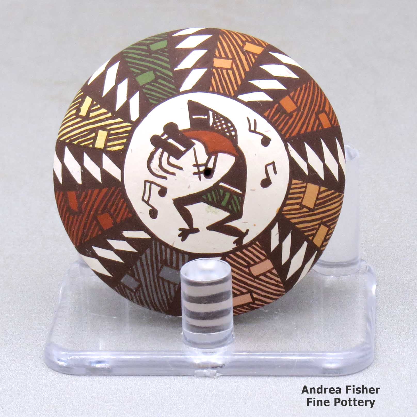Click or tap to see a larger view A miniature polychrome seed pot decorated with a kokopelli and geometric design above the shoulder made by Diane Lewis of Acoma