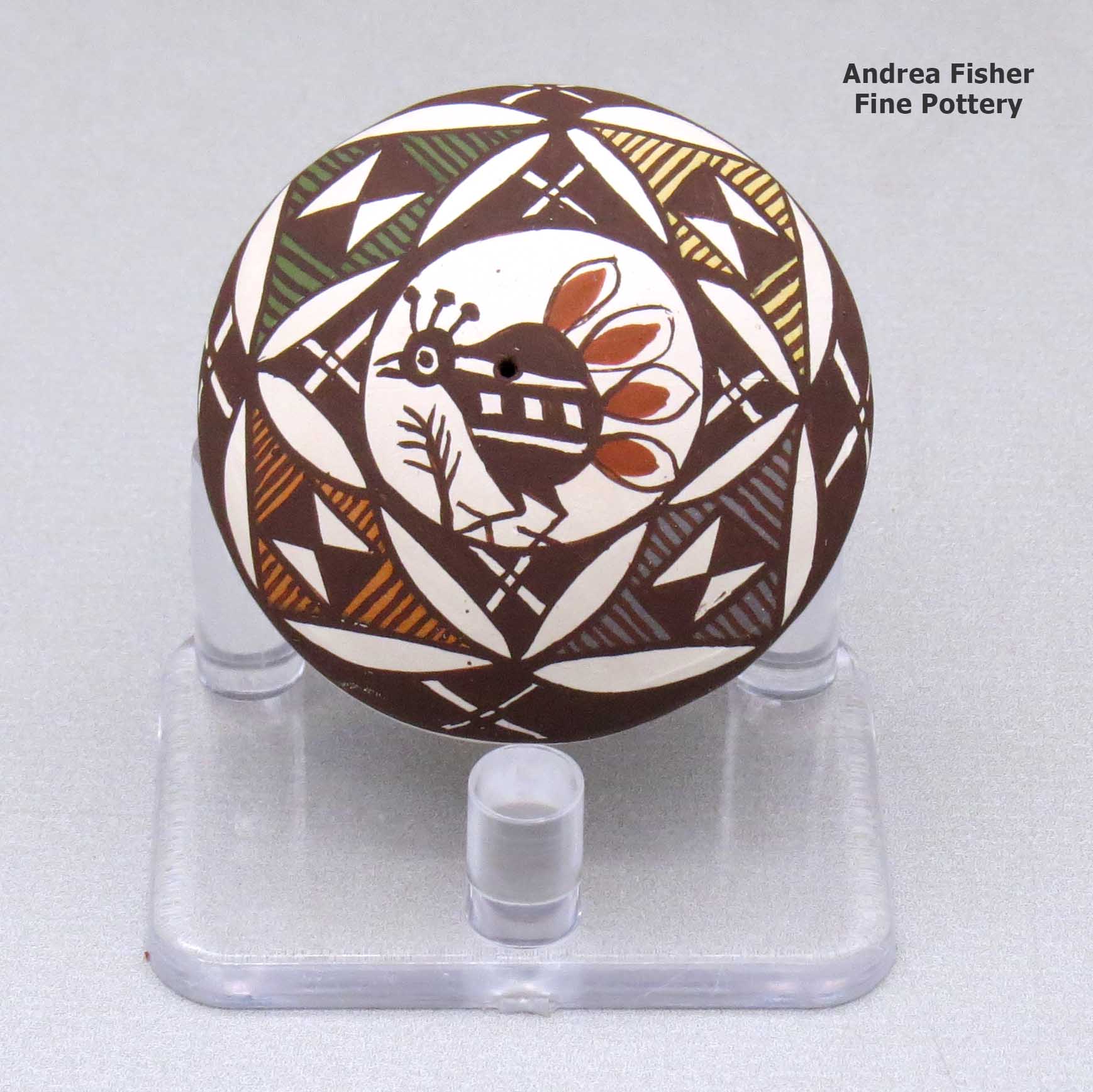 Click or tap to see a larger view A miniature polychrome seed pot decorated with a bird, branch and geometric design above the shoulder made by Diane Lewis of Acoma