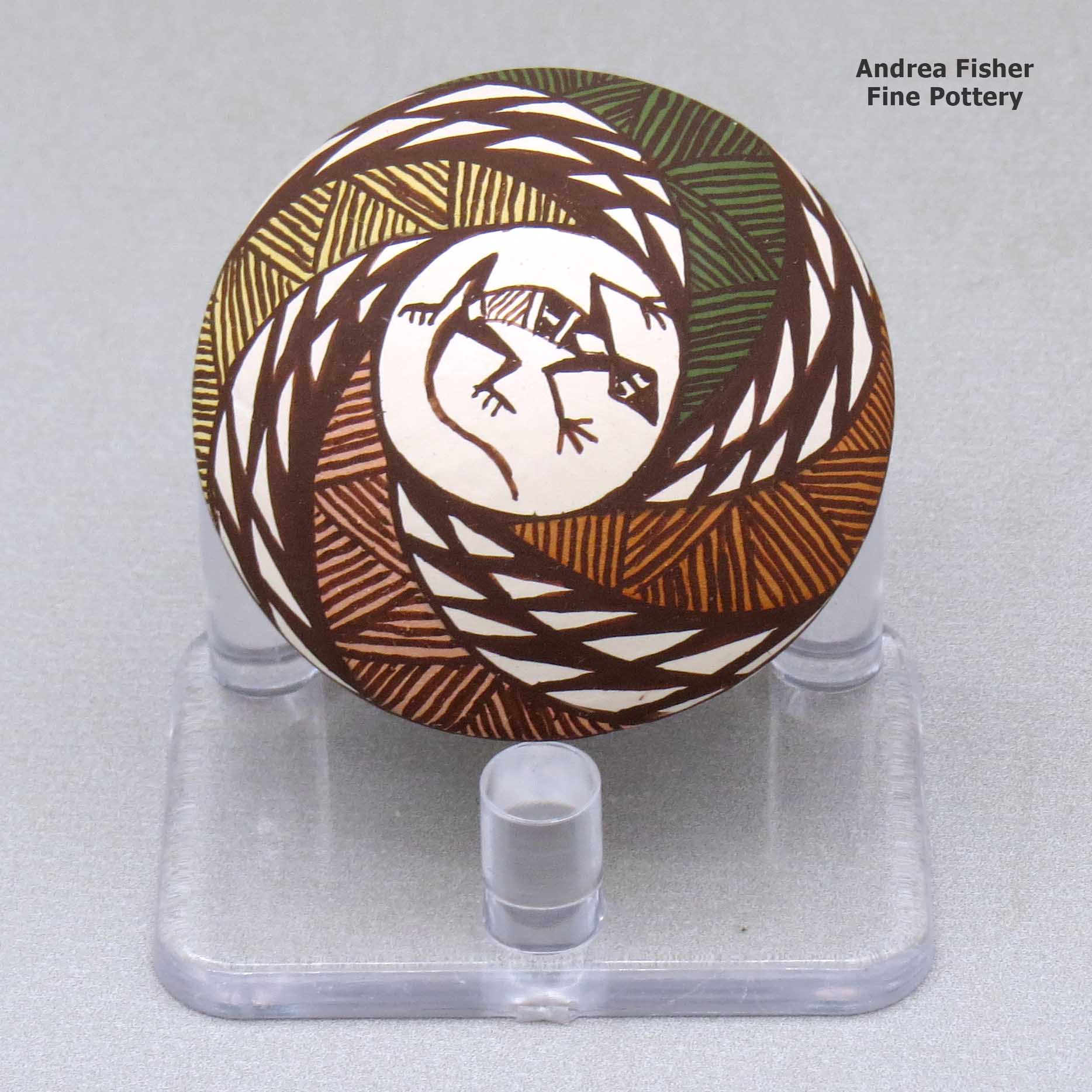 Click or tap to see a larger view A miniature polychrome seed pot decorated with a lizard, fineline and geometric design above the shoulder made by Diane Lewis of Acoma