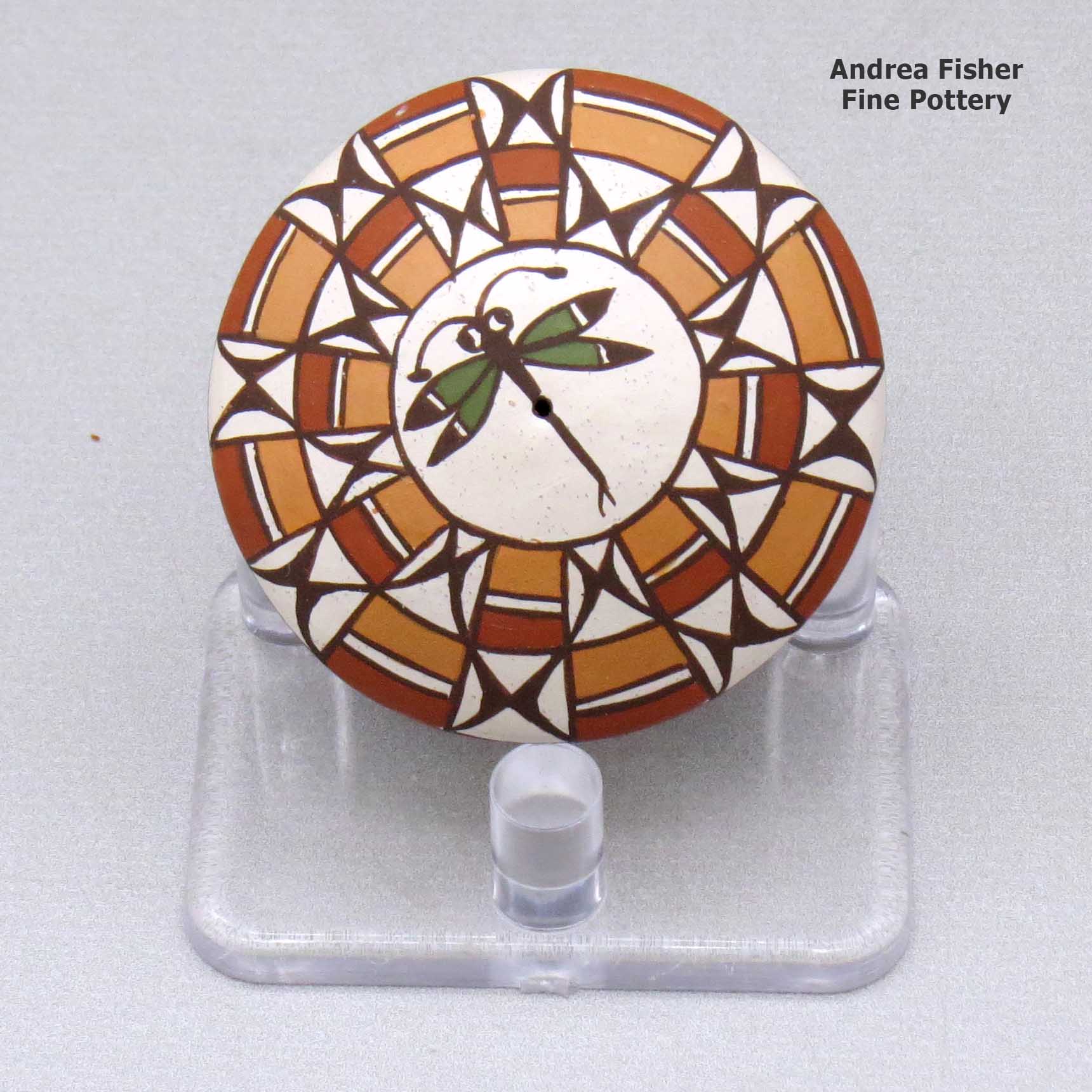 Click or tap to see a larger view A miniature polychrome seed pot decorated with a dragonfly and geometric design above the shoulder made by Diane Lewis of Acoma