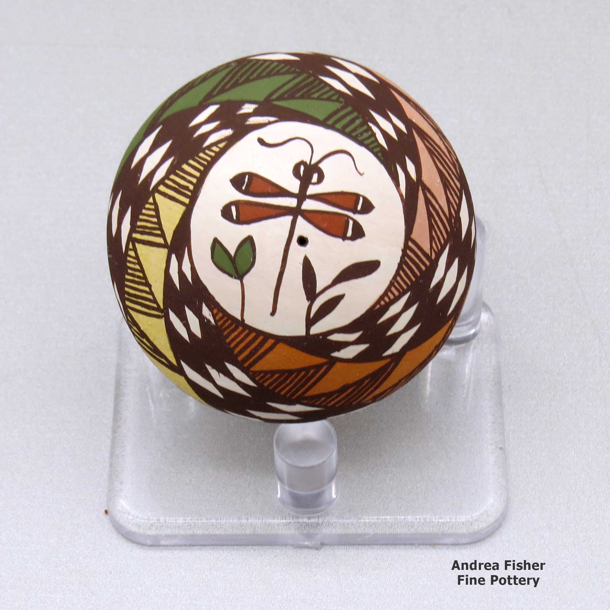 Click or tap to see a larger view A miniature polychrome seed pot decorated with a dragonfly, plant and geometric design above the shoulder made by Diane Lewis of Acoma