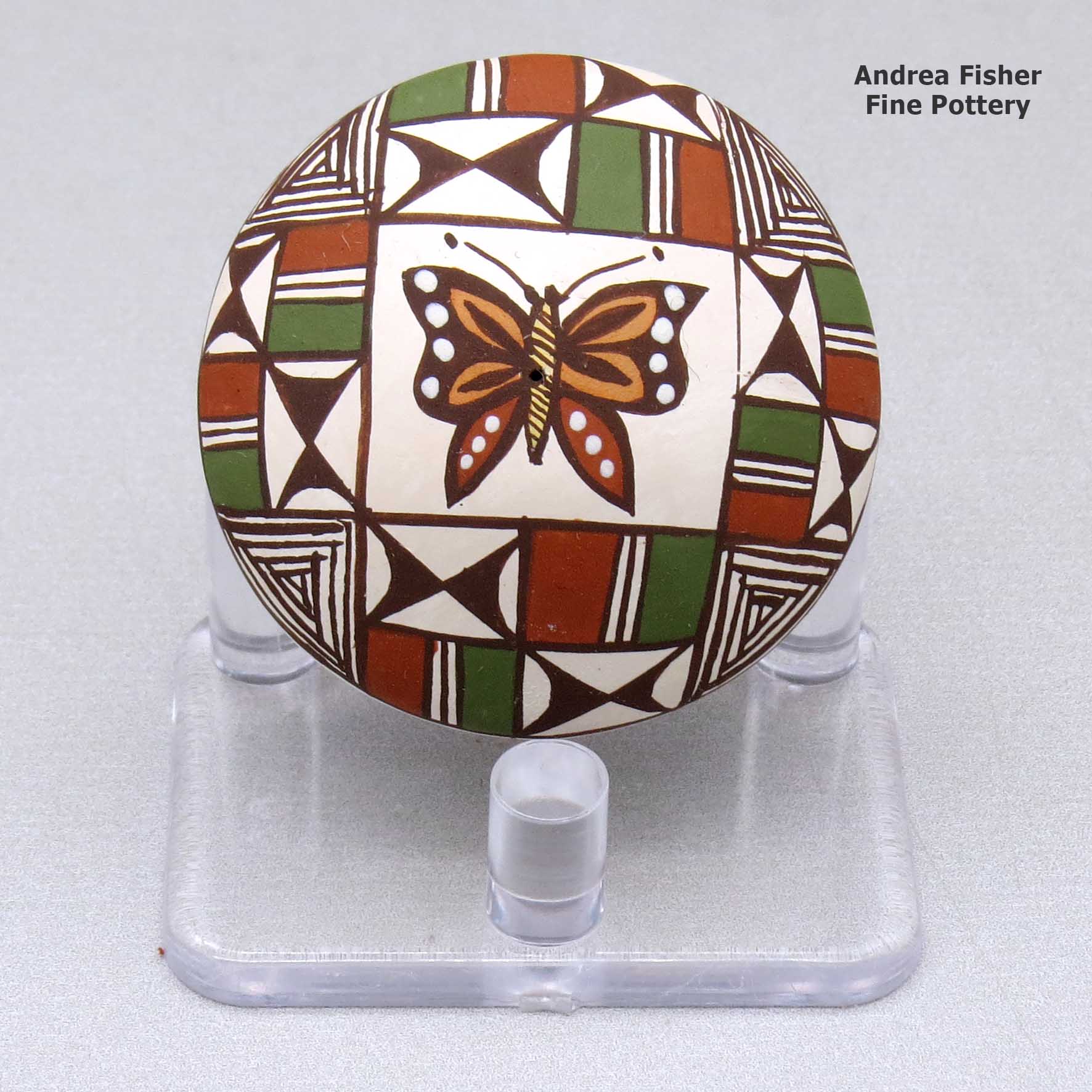 Click or tap to see a larger view A miniature polychrome seed pot decorated with a butterfly and geometric design above the shoulder made by Diane Lewis of Acoma
