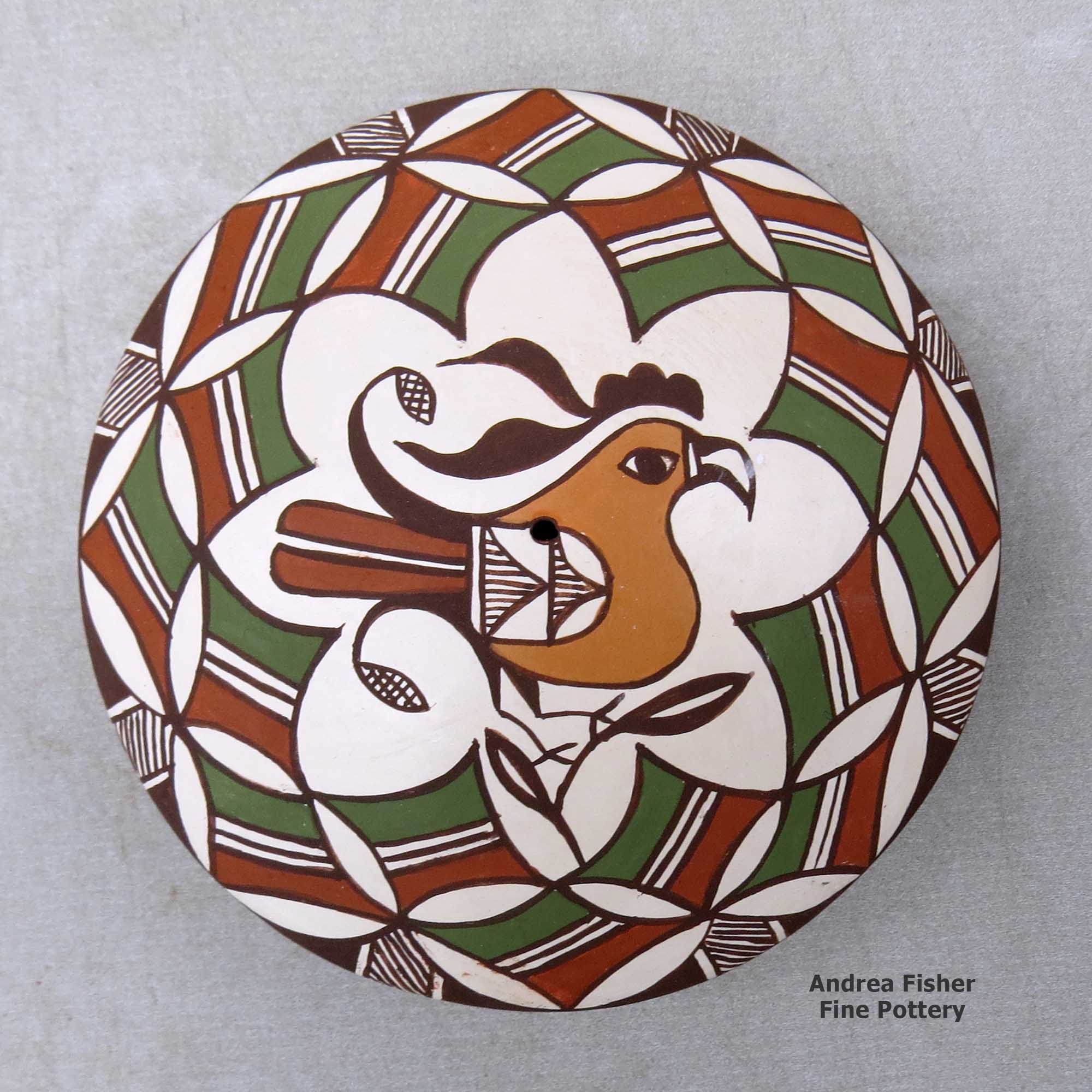 Click or tap to see a larger view A polychrome seed pot decorated above the shoulder with a parrot, branch and geometric design made by Diane Lewis of Acoma
