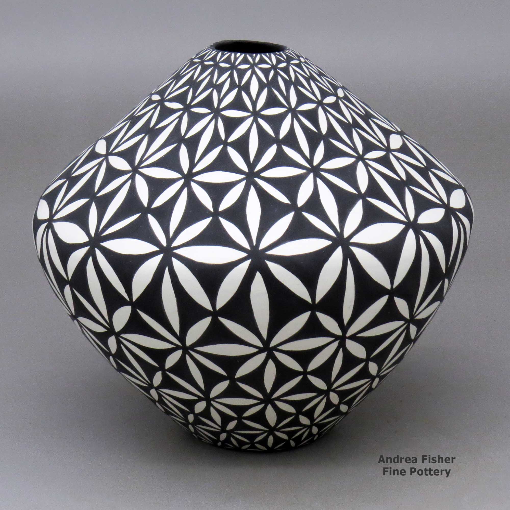 Click or tap to see a larger view A black on white jar decorated with a yucca-leaf snowflake geometric design made by Sandra Victorino of Acoma