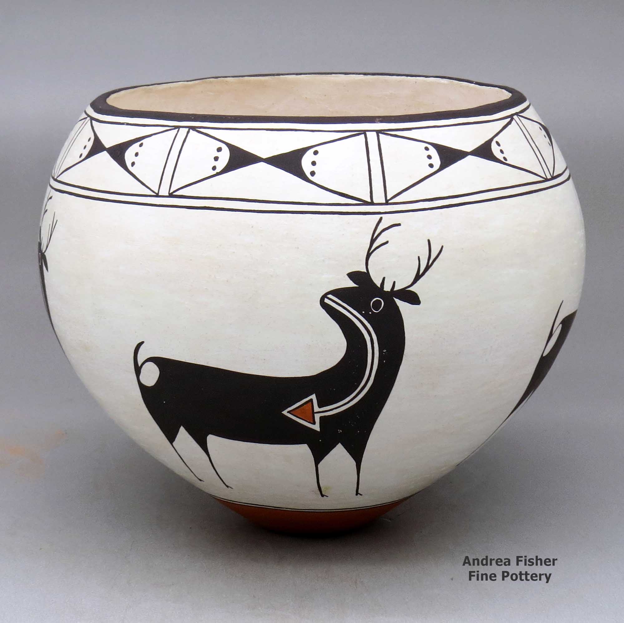Click or tap to see a larger view A polychrome bowl decorated around the body with a four-panel deer-with-heart-line design and with a butterfly geometric design around the opening made by Carmel Lewis of Acoma