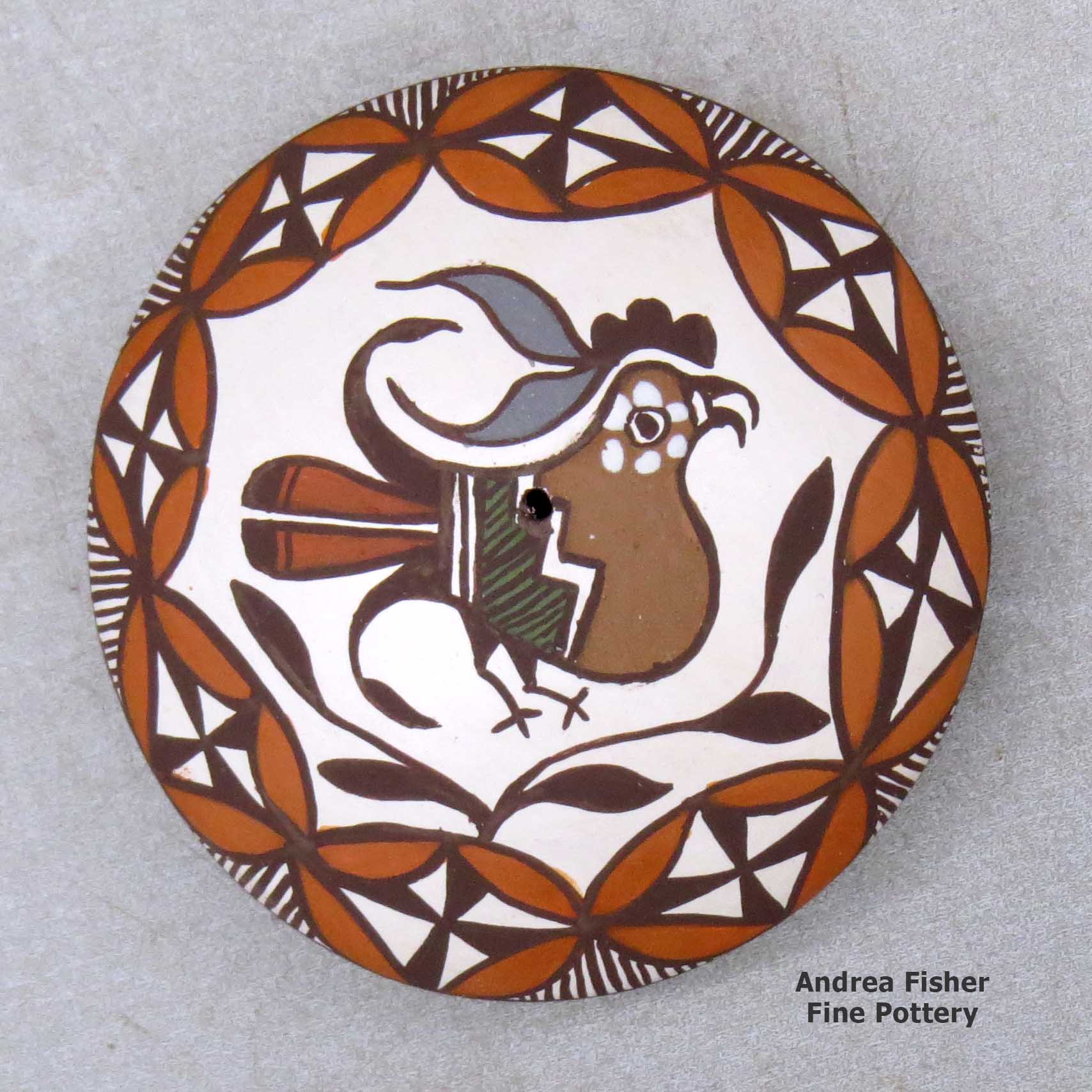Click or tap to see a larger view A miniature polychrome seed pot decorated with a parrot, branch, fineline and geometric design above the shoulder made by Diane Lewis of Acoma