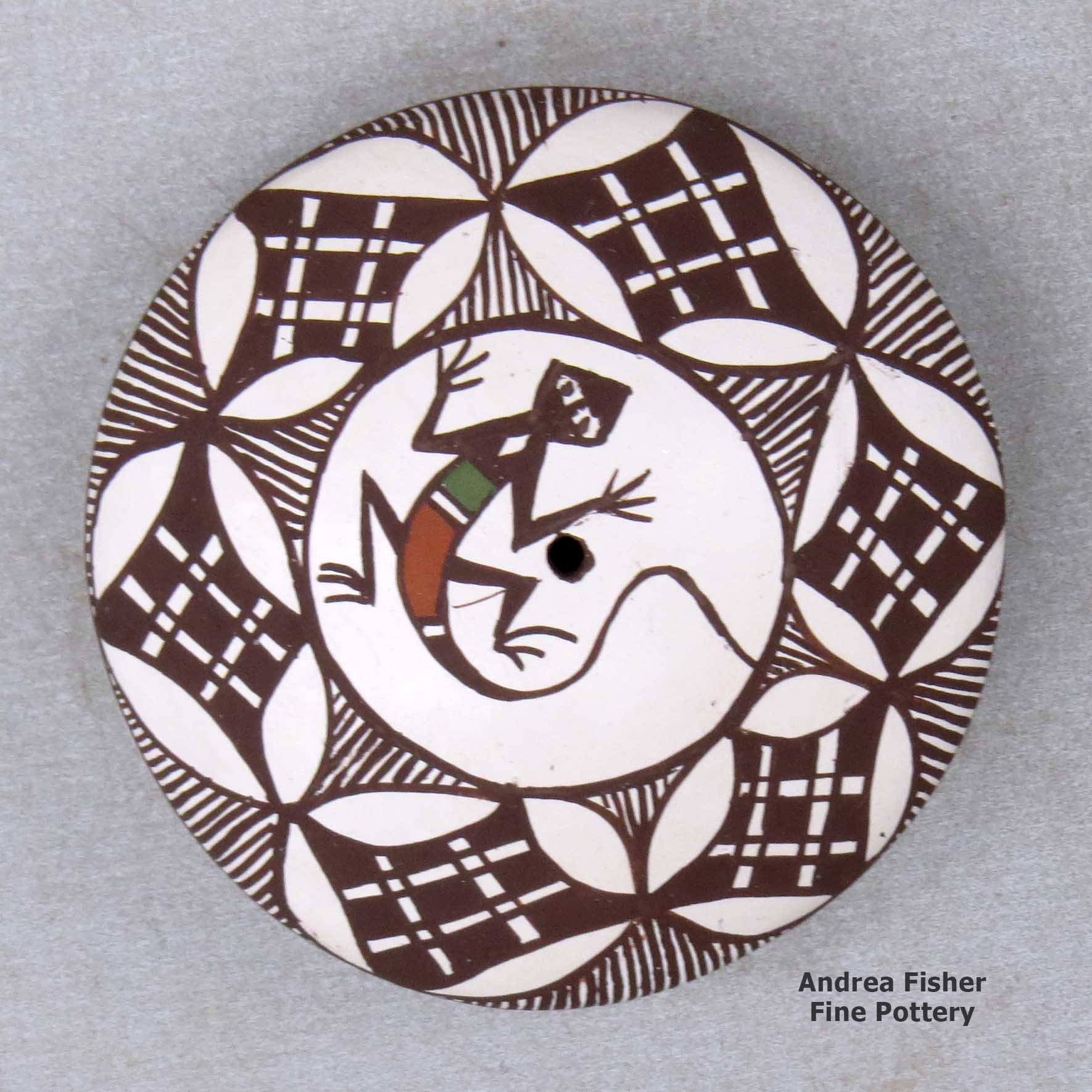 Click or tap to see a larger view A miniature polychrome seed pot decorated with a lizard, fineline and geometric design above the shoulder made by Diane Lewis of Acoma