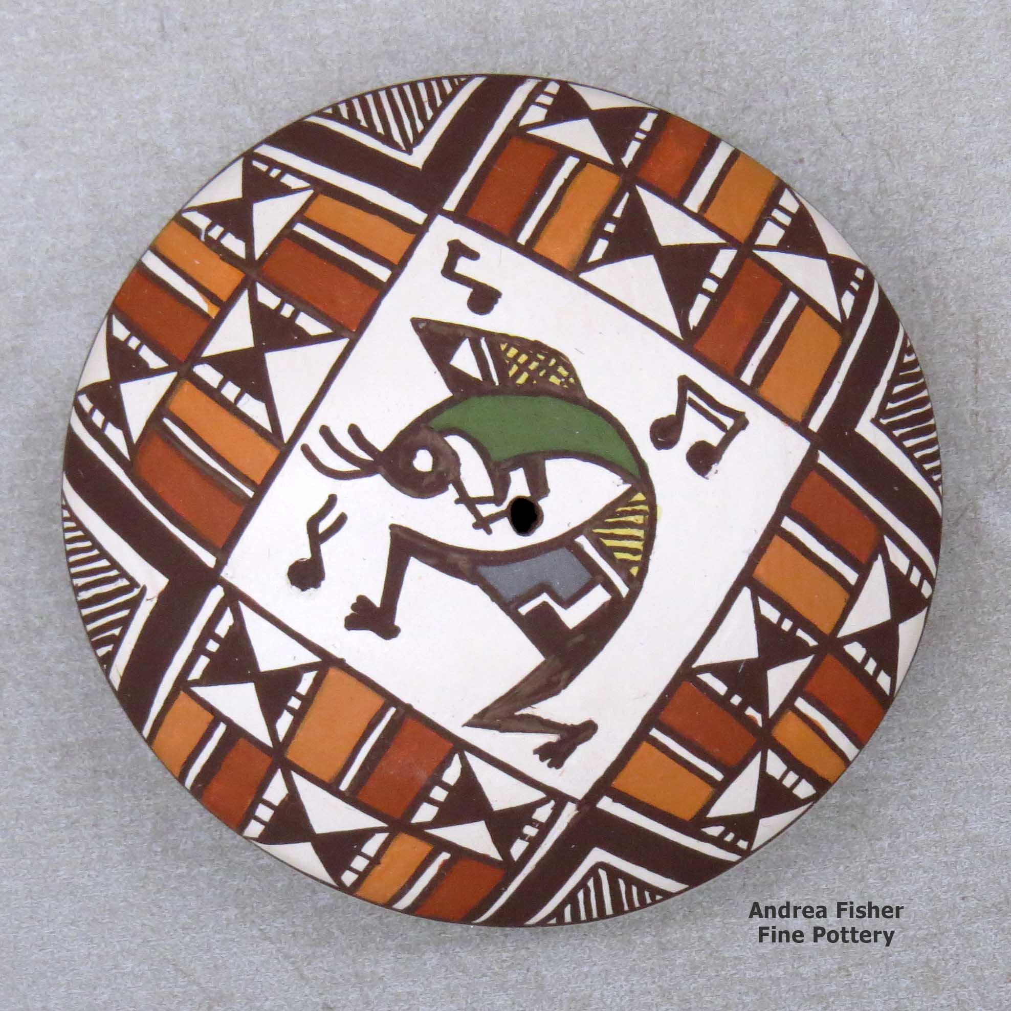 Click or tap to see a larger view A miniature polychrome seed pot decorated with a kokopelli and geometric design above the shoulder made by Diane Lewis of Acoma
