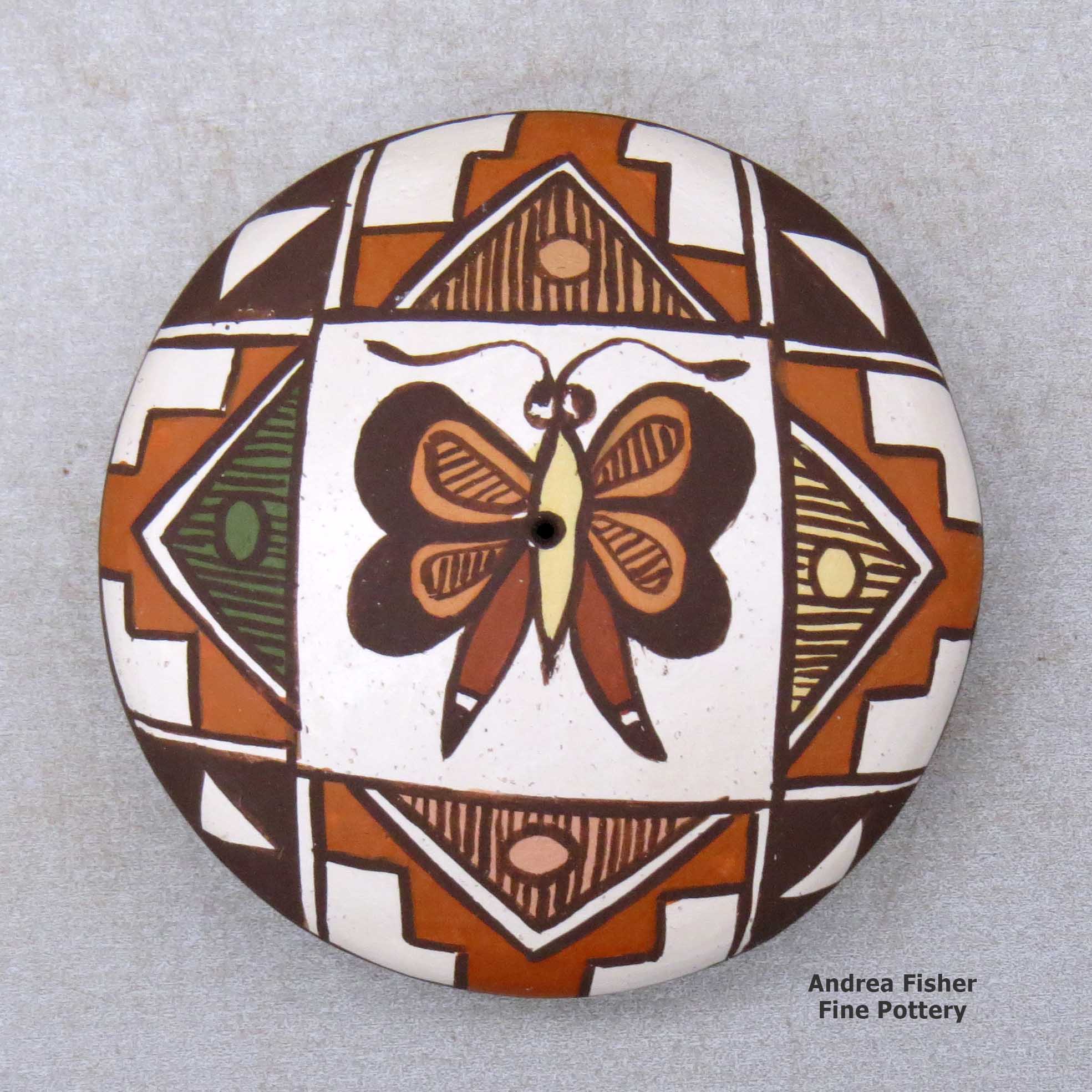 Click or tap to see a larger view A miniature polychrome seed pot decorated with a butterfly, fineline and geometric design above the shoulder made by Diane Lewis of Acoma