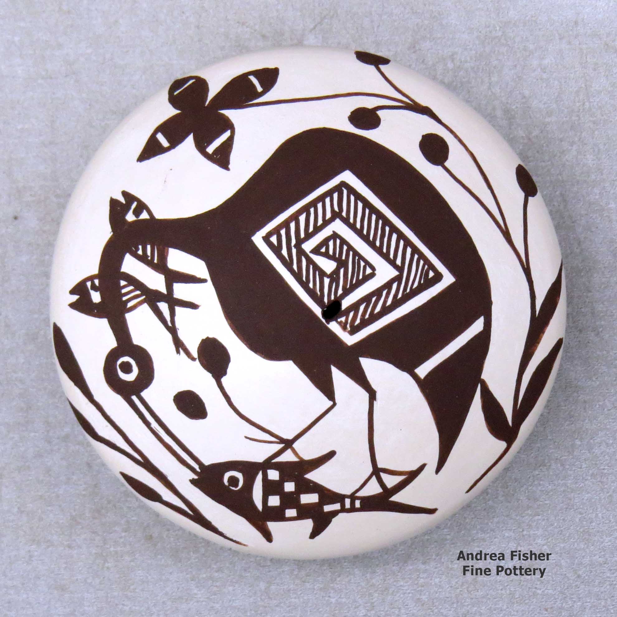 Click or tap to see a larger view A miniature black on white seed pot decorated with a cloudeater, fish, vine and geometric design above the shoulder made by Diane Lewis of Acoma