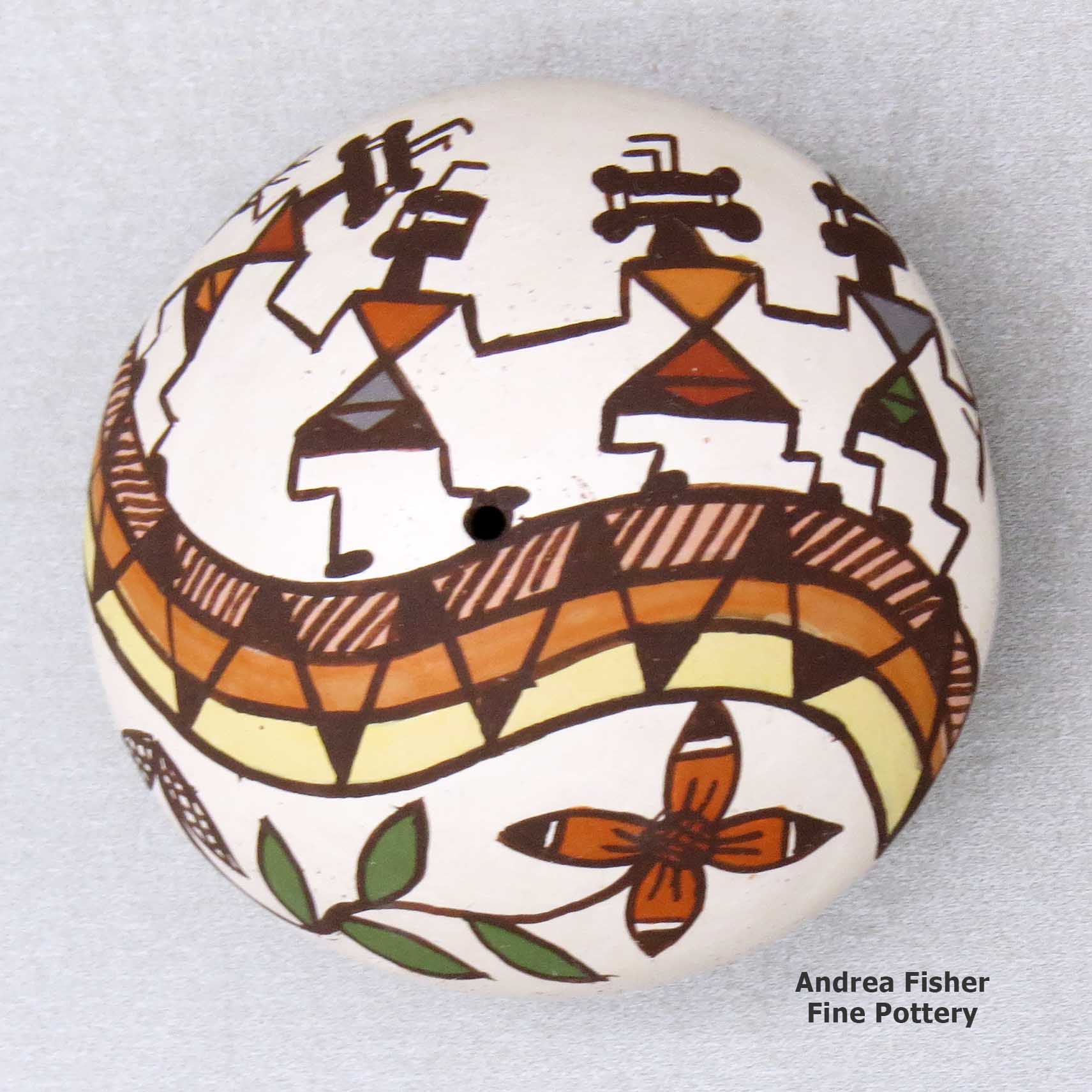 Click or tap to see a larger view A miniature polychrome seed pot decorated with a pueblo dancer, rainbow, vine and geometric design above the shoulder made by Diane Lewis of Acoma