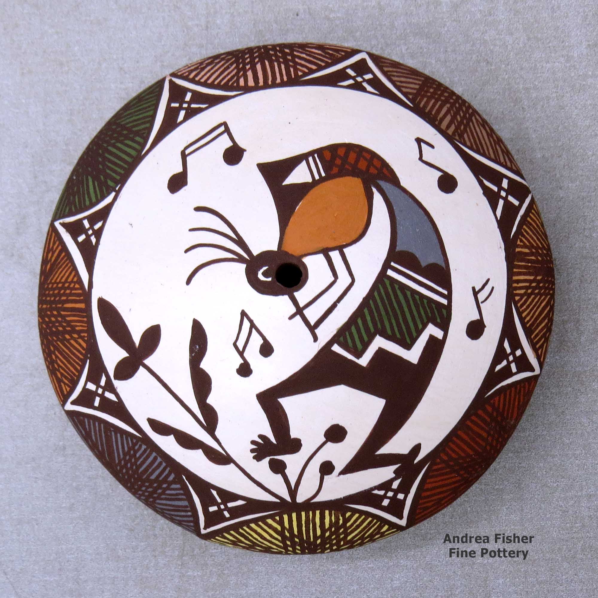 Click or tap to see a larger view A polychrome seed pot decorated with a kokopelli, vine, fineline and geometric design above the shoulder made by Diane Lewis of Acoma