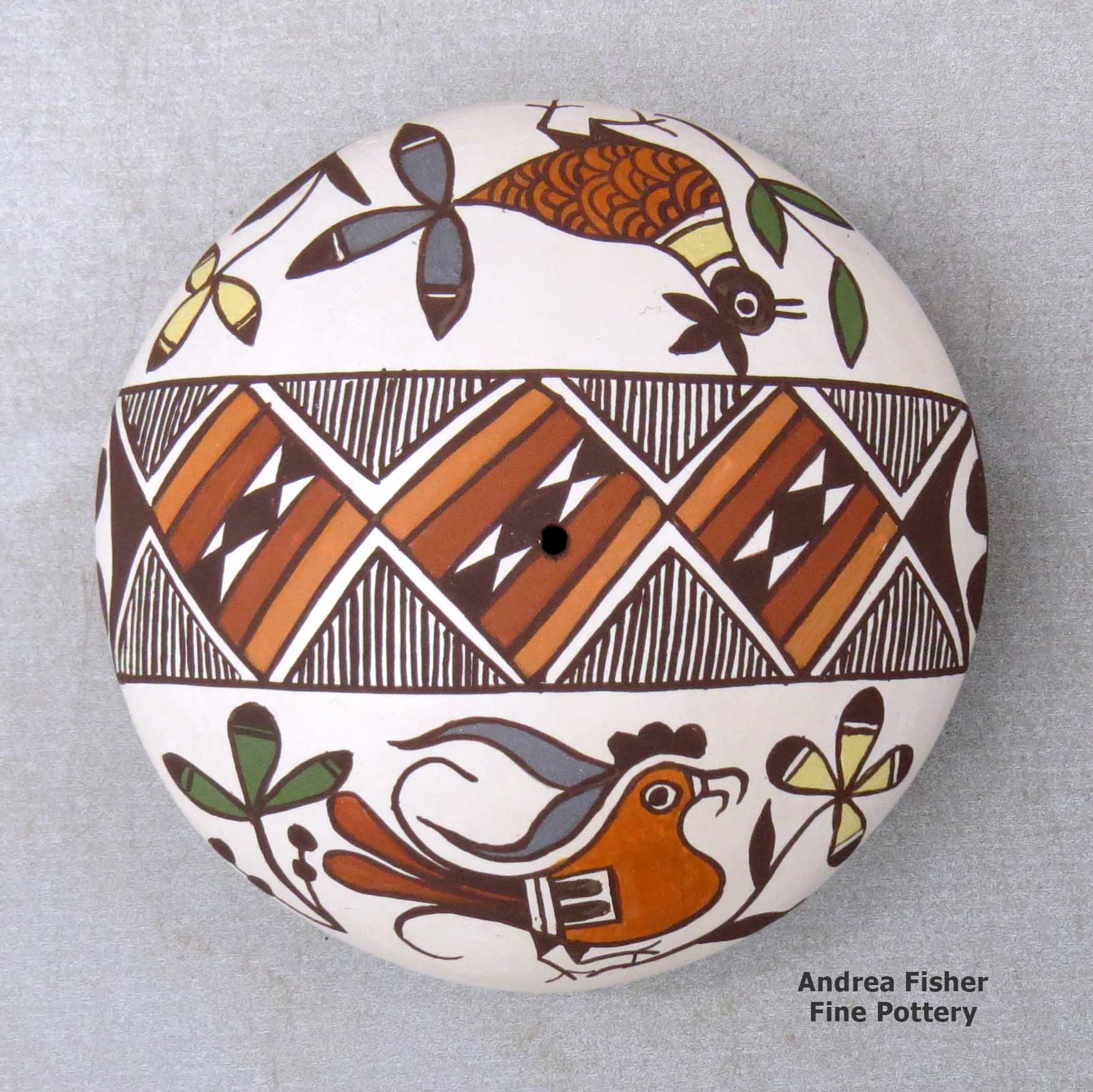 Click or tap to see a larger view A polychrome seed pot decorated with a parrot, bird, branch, fineline and geometric design above the shoulder made by Diane Lewis of Acoma