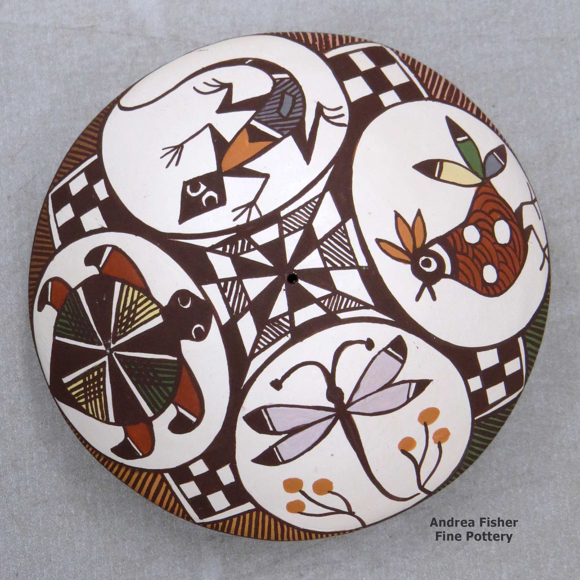 Click or tap to see a larger view A polychrome seed pot decorated above the shoulder with a bird, lizard, turtle, dragonfly and geometric design made by Diane Lewis of Acoma