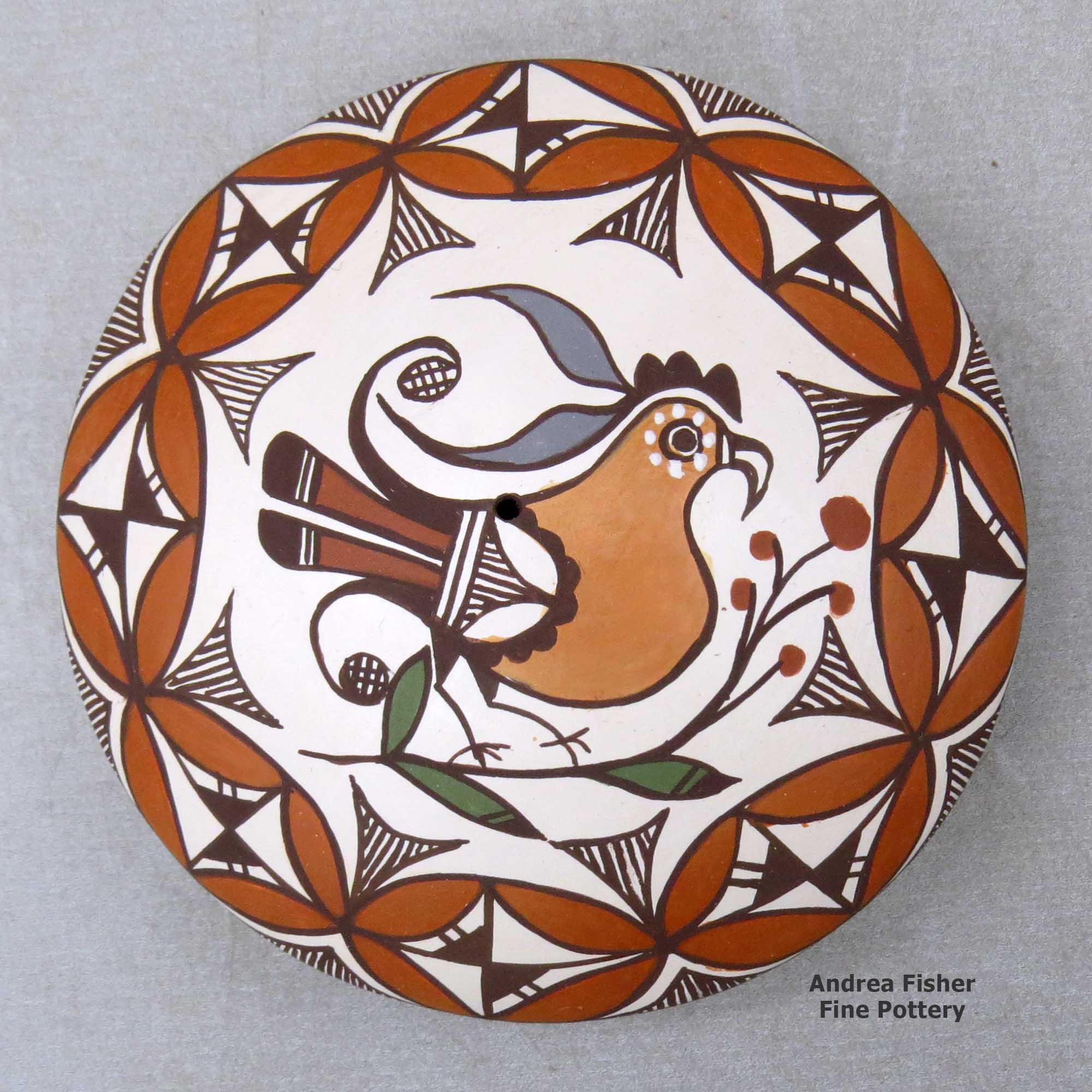 Click or tap to see a larger view A polychrome seed pot decorated above the shoulder with a parrot, branch and geometric design made by Diane Lewis of Acoma