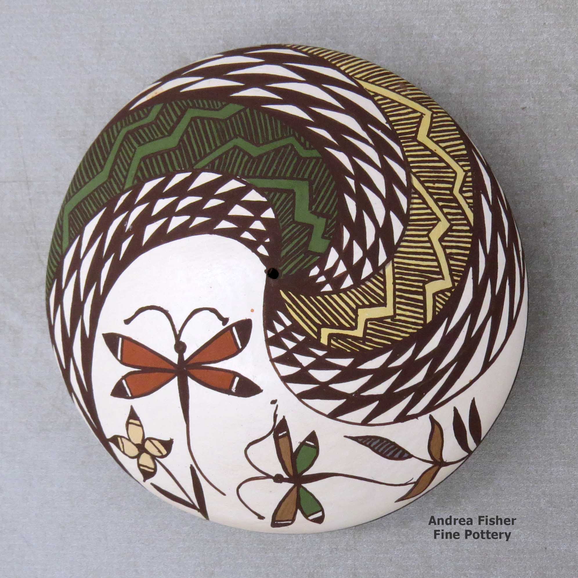 Click or tap to see a larger view A polychrome seed pot decorated above the shoulder with a dragonfly, fish, fineline and geometric design made by Diane Lewis of Acoma