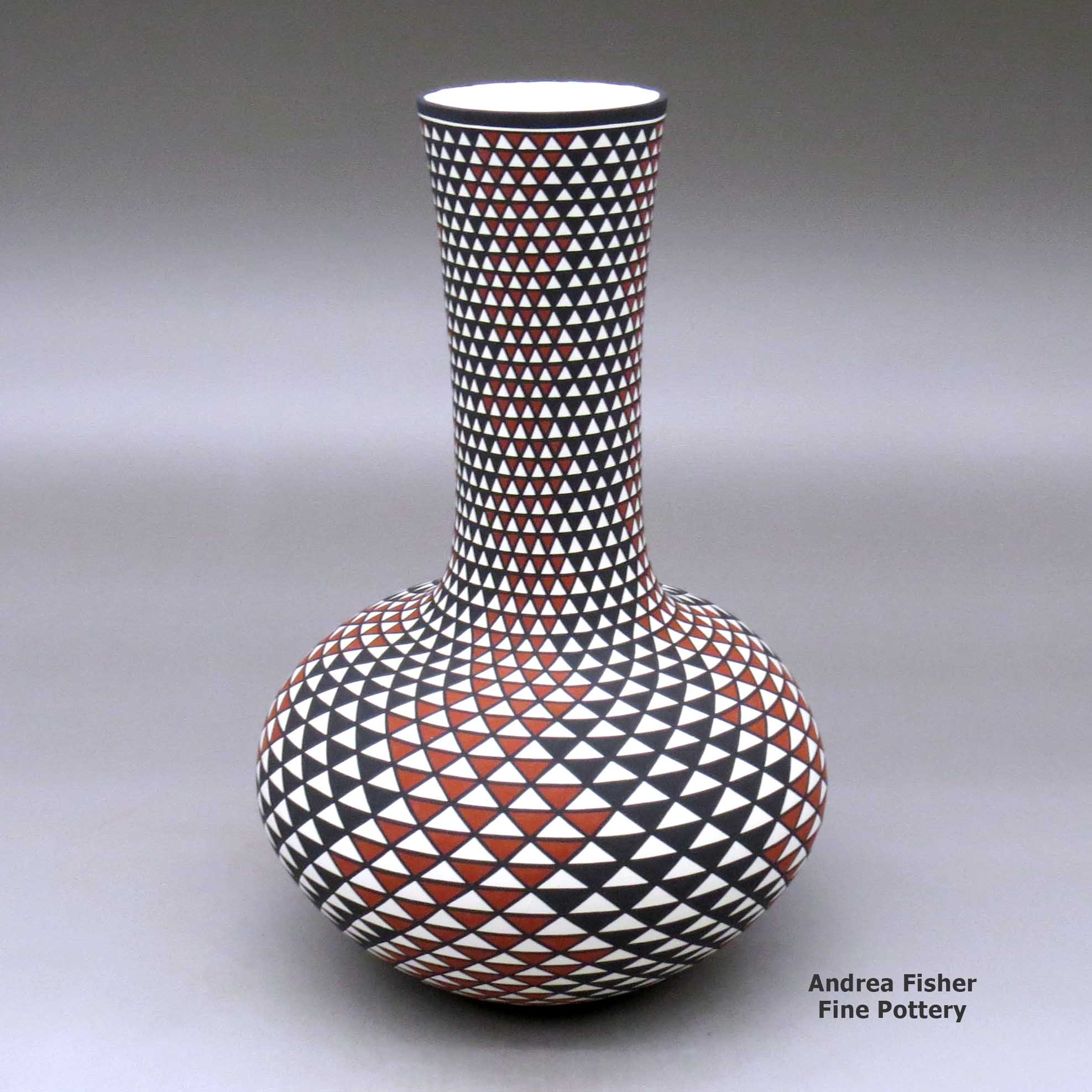 Click or tap to see a larger view A tall neck polychrome vase decorated with a spiral mesa geometric design made by Paula Estevan of Acoma