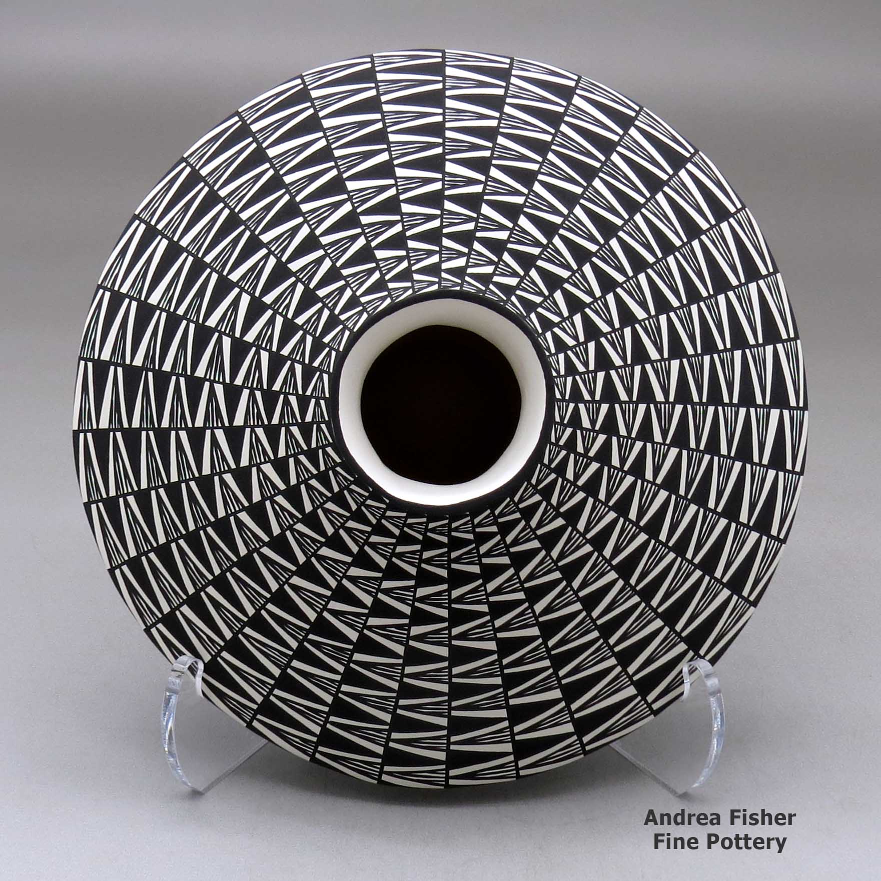 Click or tap to see a larger view A black on white low shouldered jar decorated with a geometric design made by Paula Estevan of Acoma