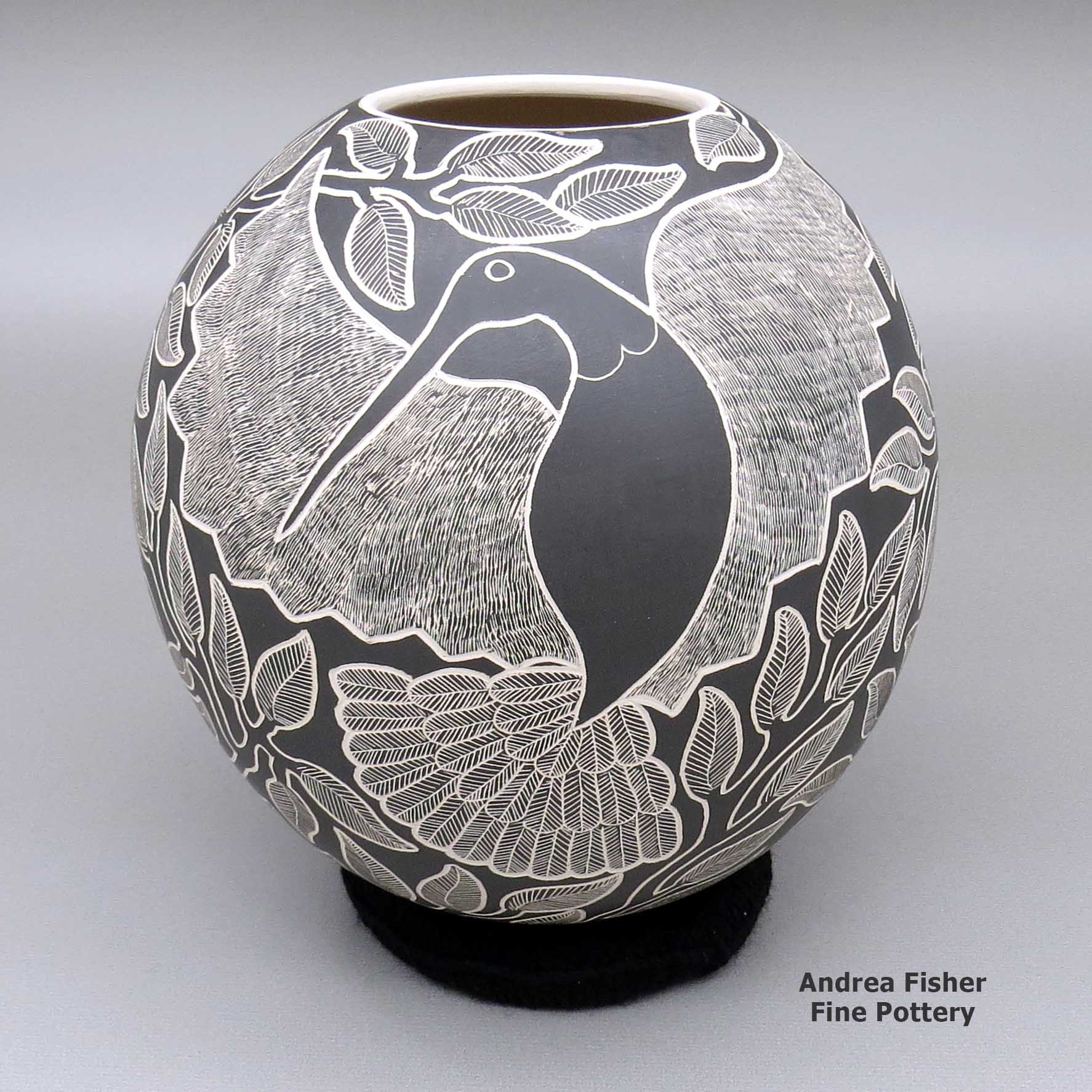 Lorenza Quezada created this piece, Click or tap to see a larger version Blackandwhitejarwithasgraffitohummingbird,flower,branch,andleafdesign, Click or tap to see a larger version