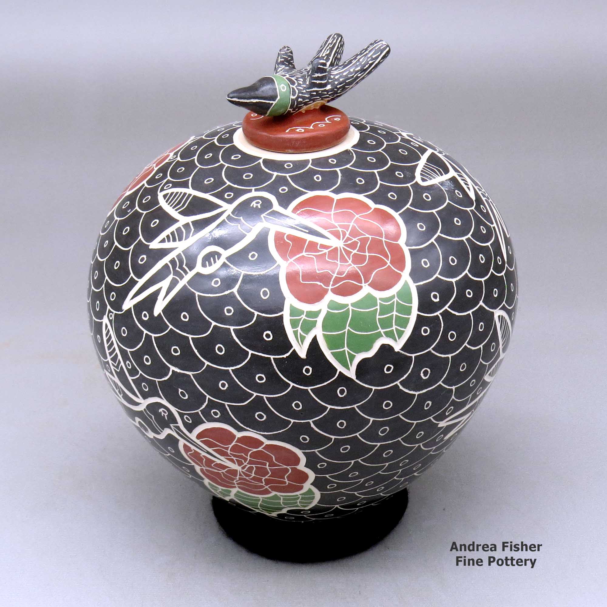 Click or tap to see a larger view A polychrome jar decorated with a lightly carved, sgraffito and painted hummingbird, flower and geometric design, with a matching hummingbird lid made by Vidal Corona of Mata Ortiz and Casas Grandes