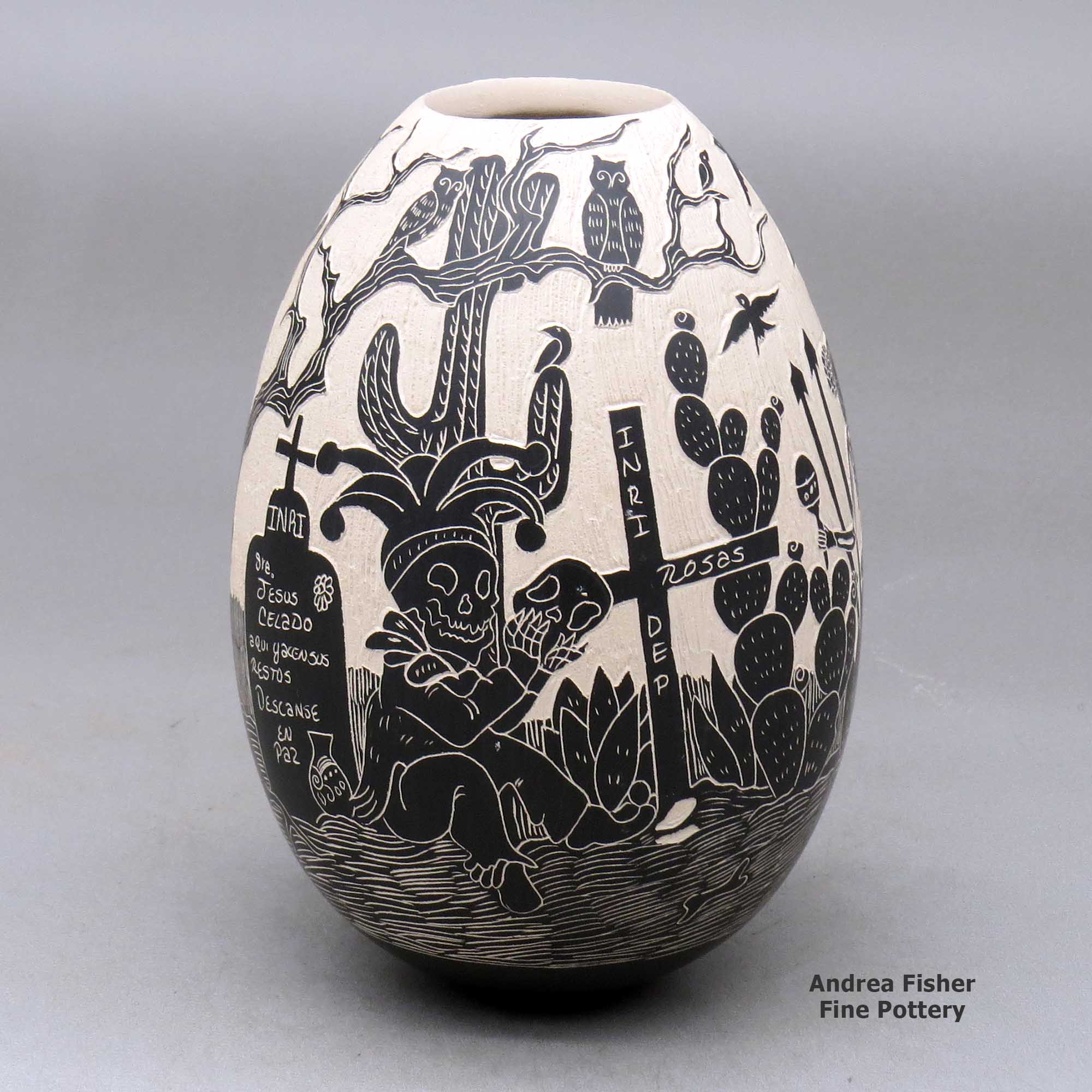 Click or tap to see a larger view A black on white jar decorated with a sgraffito Day of the Dead design made by Diana Loya of Mata Ortiz and Casas Grandes