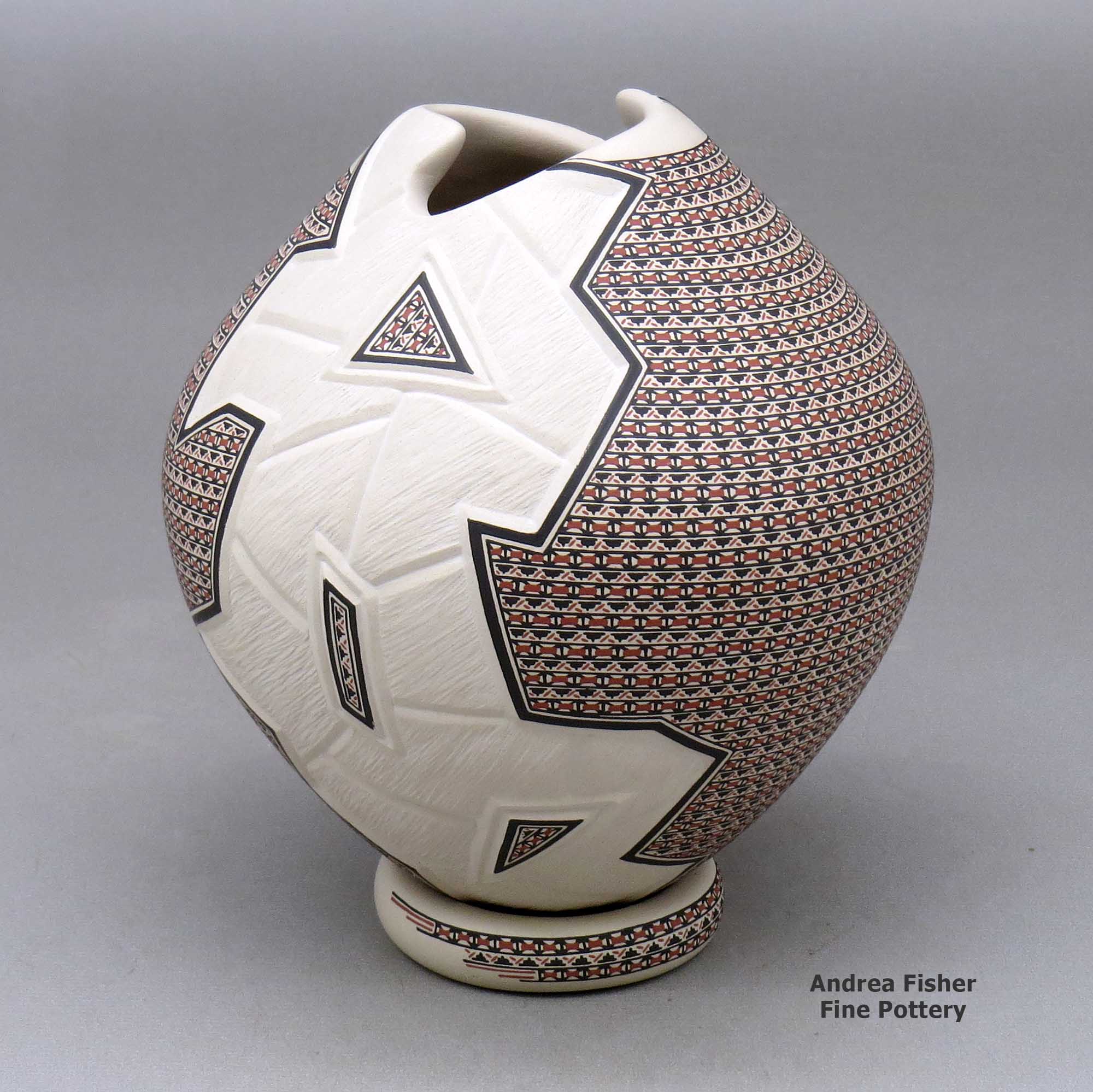 Click or tap to see a larger view A polychrome jar with a geometric cut opening and decorated with a lightly carved, sgraffito and painted geometric design, with a custom matching stand made by Karla Lopez Cota of Mata Ortiz and Casas Grandes