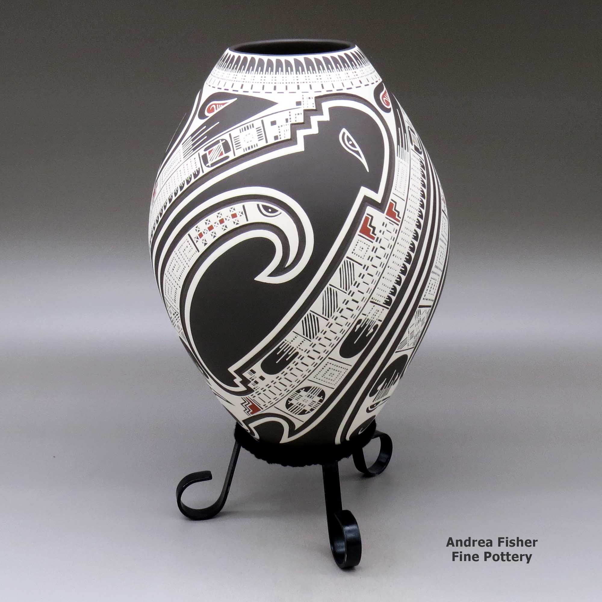 Click or tap to see a larger view A polychrome jar lightly carved and painted with a three panel serpent, bird element, sickle and geometric design made by Lazaro Ozuna of Mata Ortiz and Casas Grandes