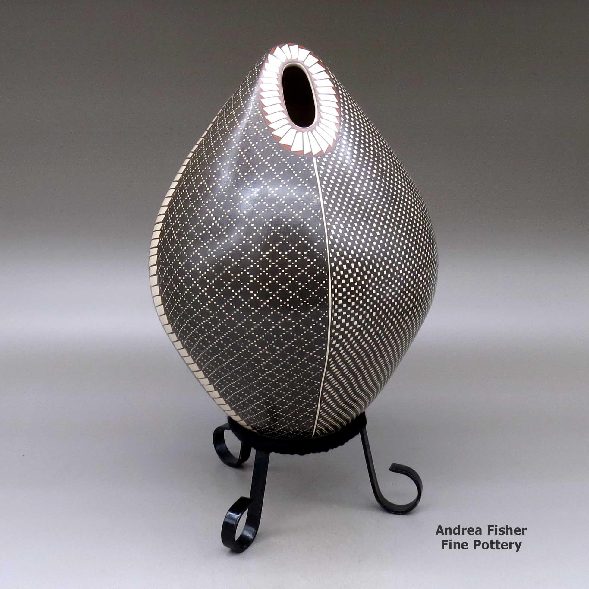 Click or tap to see a larger view A polychrome egg-shaped seed pot decorated with a four panel checkerboard and geometric design made by Luz Elva Gutierrez of Mata Ortiz and Casas Grandes