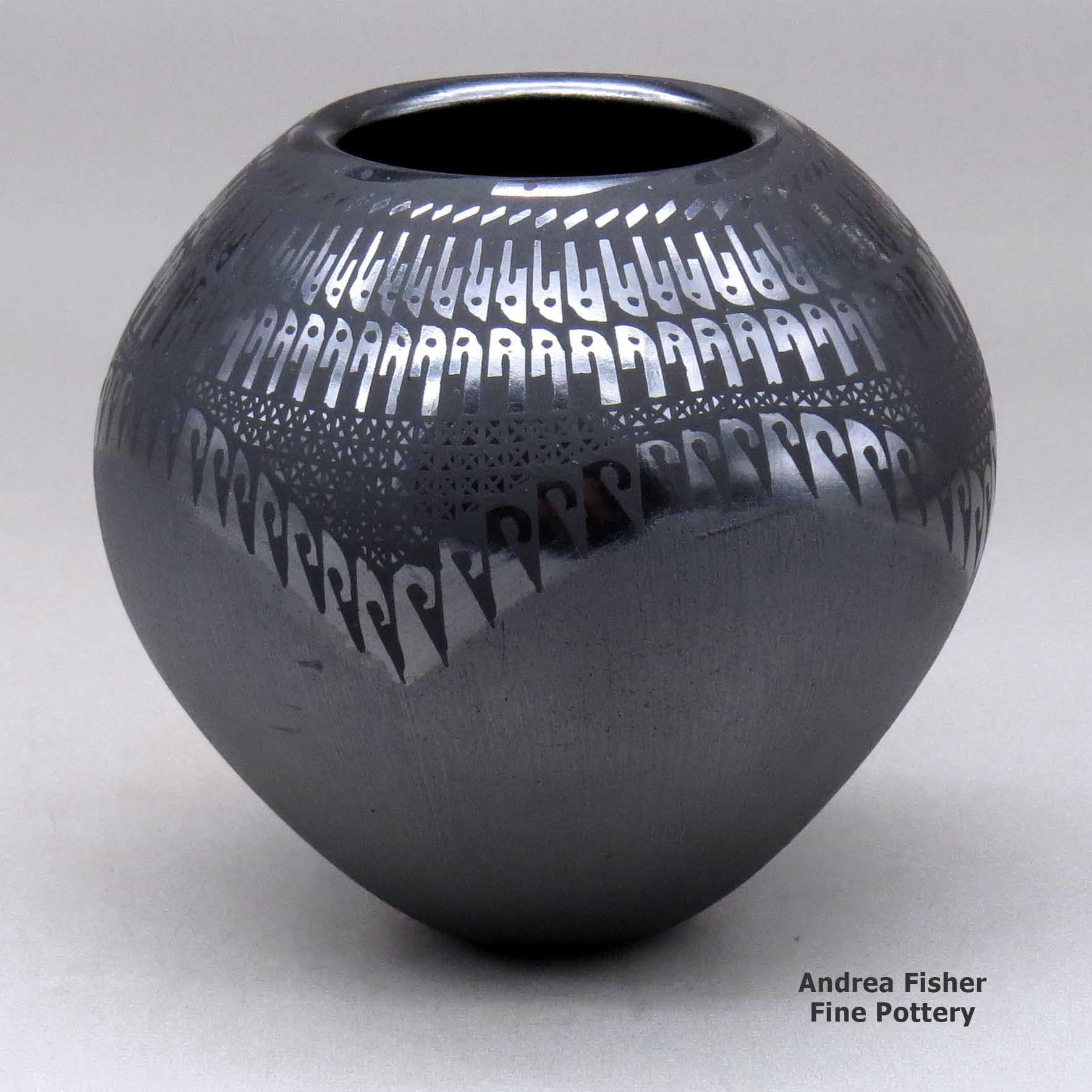 Click or tap to see a larger view A black on black jar decorated with a geometric design made by Susy Martinez of Mata Ortiz and Casas Grandes