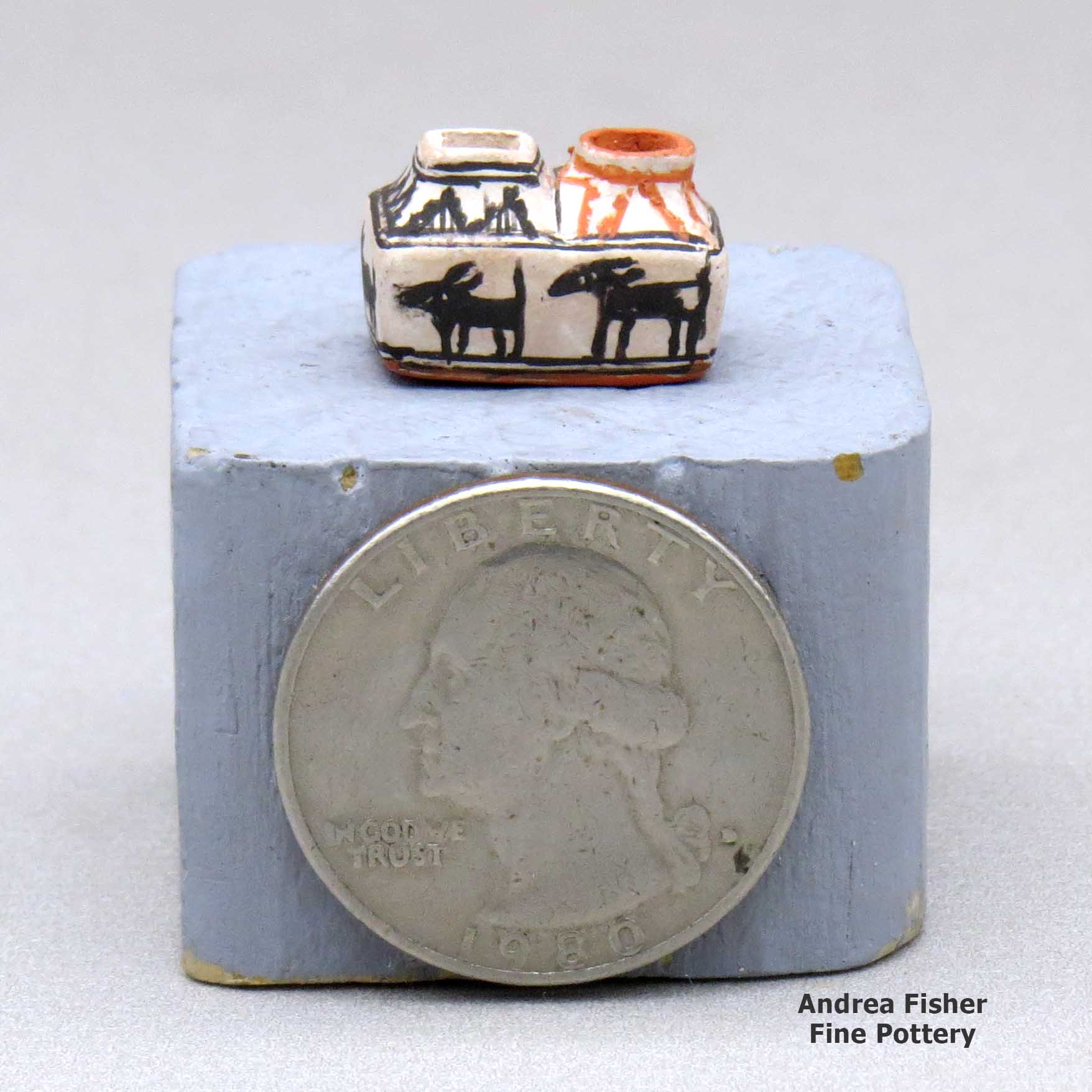 Click or tap to see a larger view A miniature polychrome two-opening jar decorated with an animal and geometric design made by Thomas Natseway of Laguna