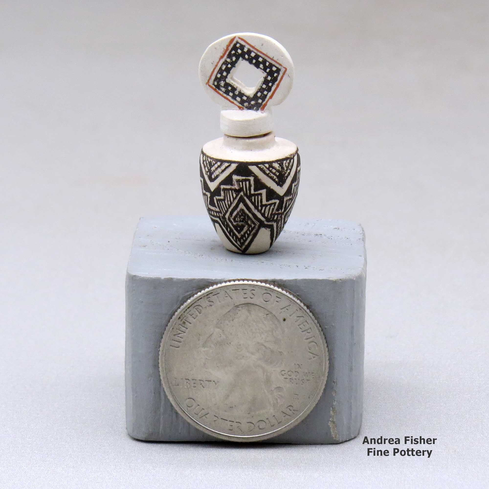 Click or tap to see a larger view A miniature black on white jar decorated with an ancient Mogollon geometric design and with a cutout in the lid made by Thomas Natseway of Laguna
