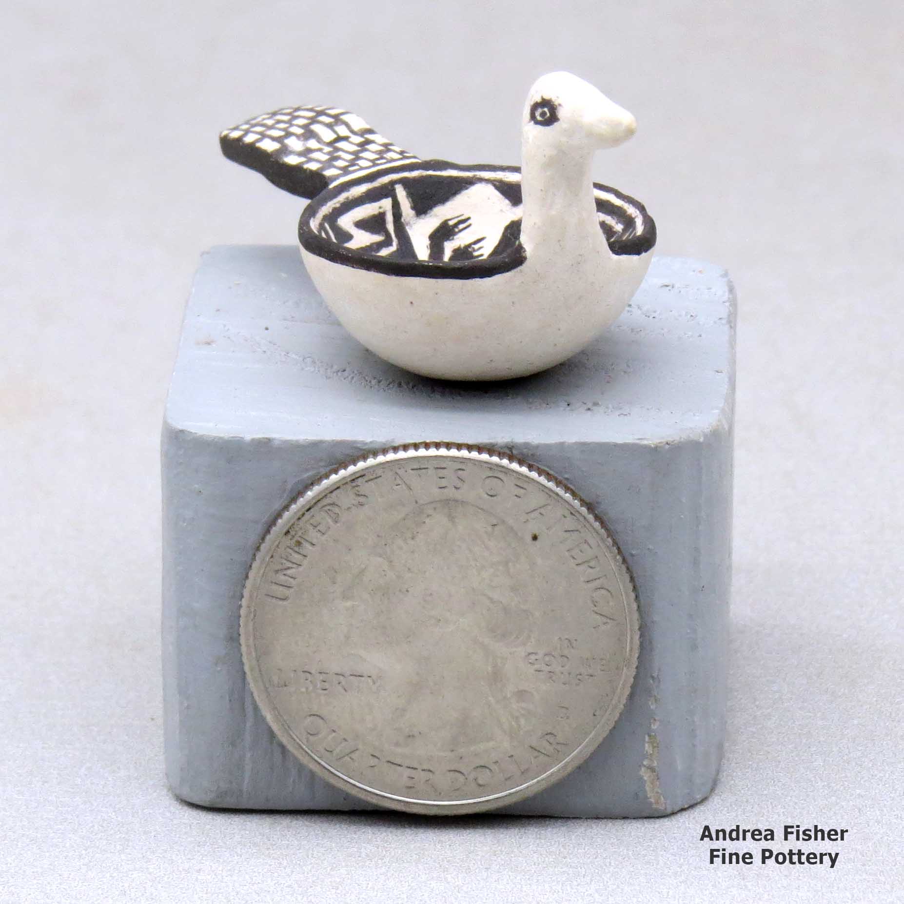 Click or tap to see a larger view A miniature black on white bird bowl decorated with a Mimbres and geometric design made by Thomas Natseway of Laguna