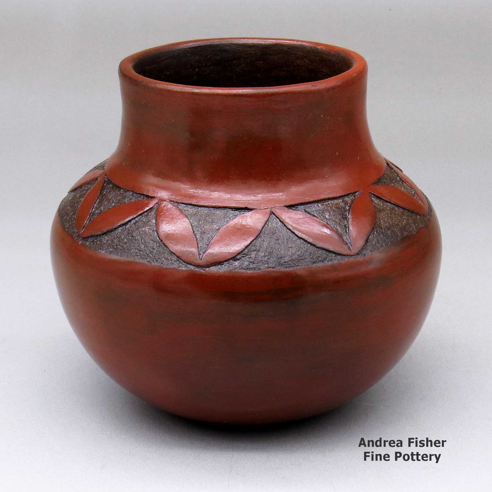 Click or tap to see a larger view A brown jar with a sgraffito geometric design above the shoulder made by Sue Williams of Dineh