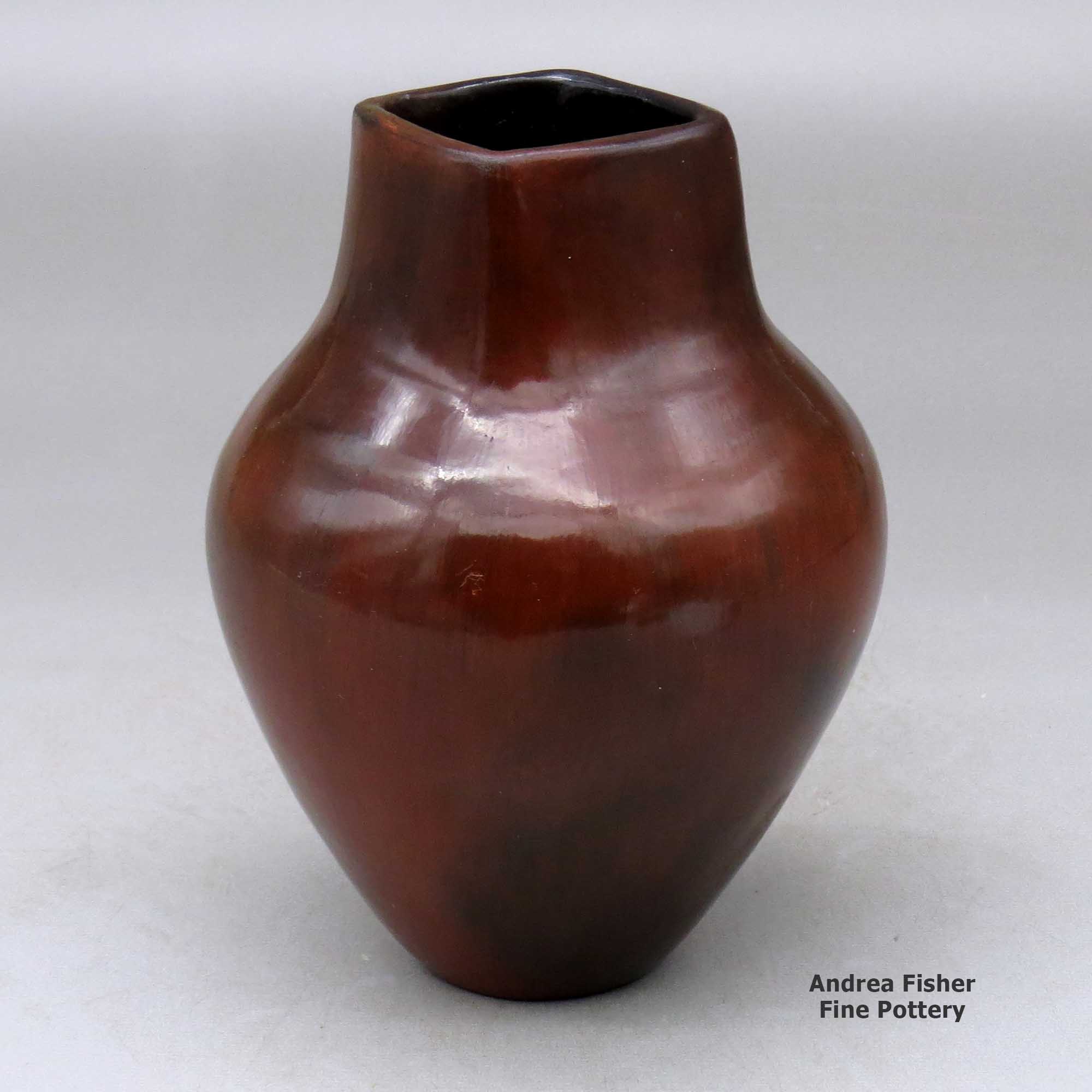 Click or tap to see a larger view A polished brown vase decorated with fire clouds and a short, square neck made by Alice Cling of Dineh