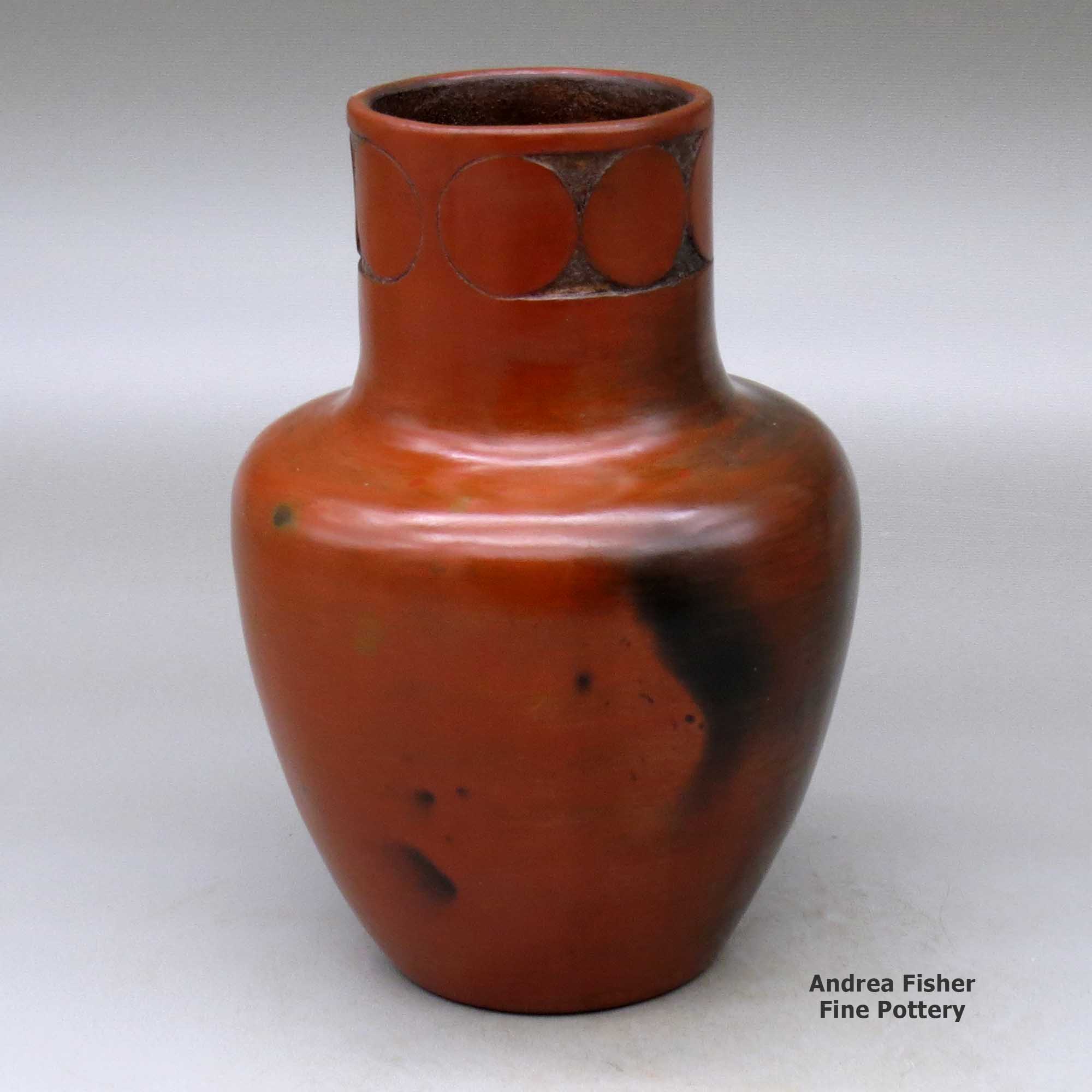 Click or tap to see a larger view A polished brown jar with fire clouds decorated around the neck with a sgraffito geometric design made by Sue Williams of Dineh