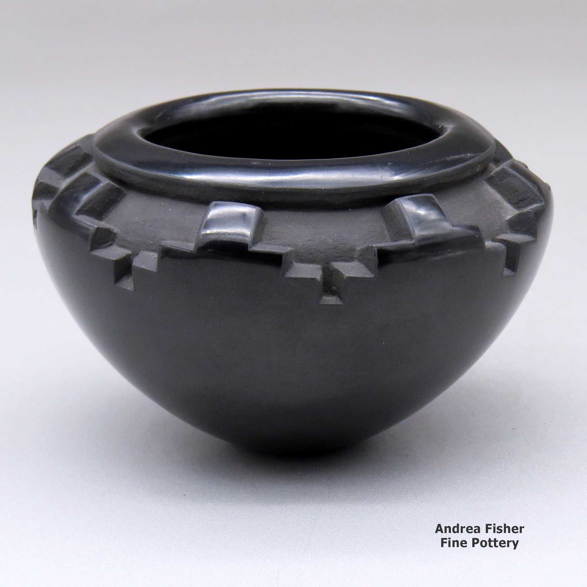 Click or tap to see a larger view A small black bowl carved with a band of kiva step geometric design around and above the shoulder made by Effie Garcia of Santa Clara